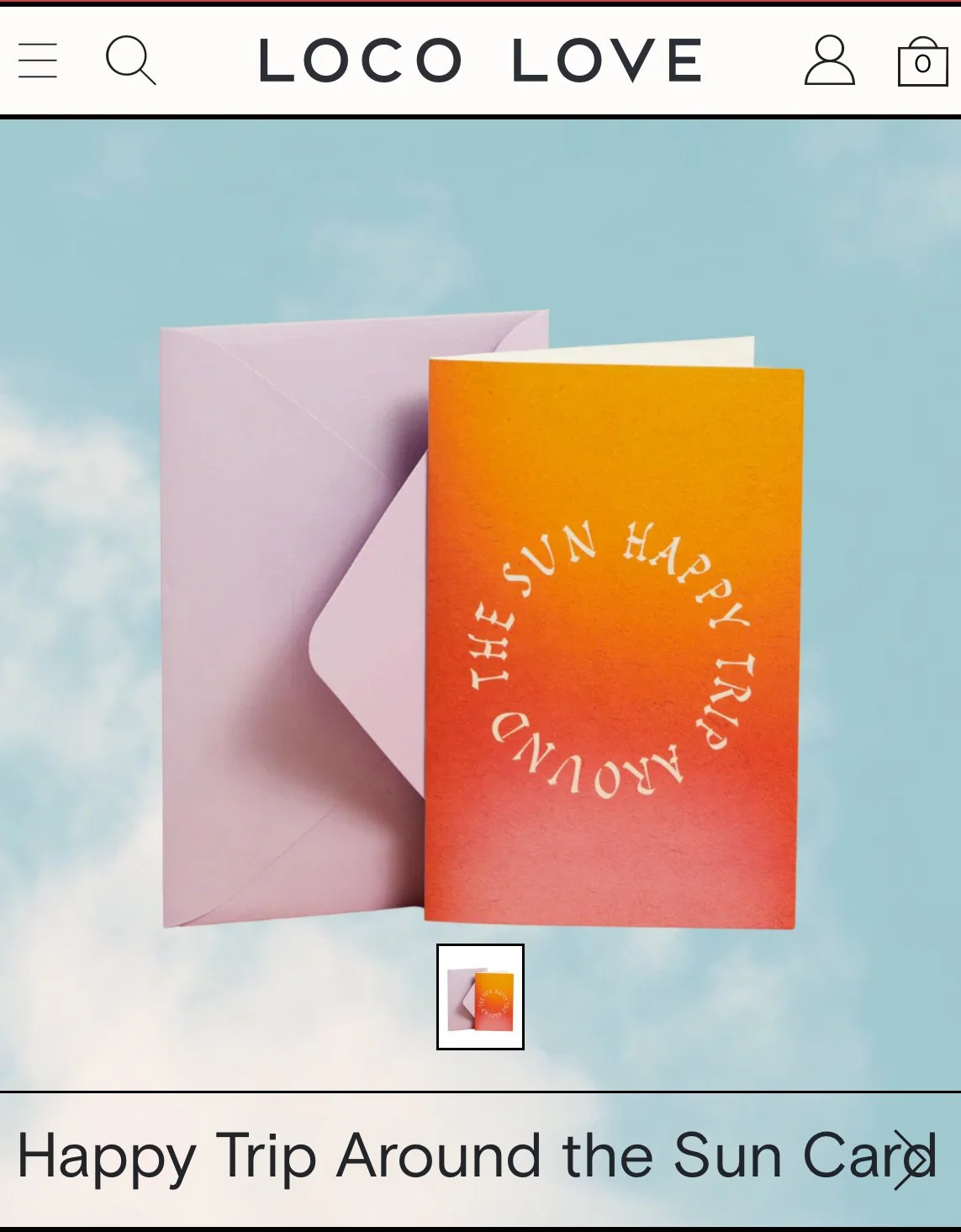 A greeting card with a gradient of red to orange, featuring the phrase "THE SUN HAPPY TRIP AROUND THE SUN" in a circular pattern. The card is partially inserted into a light pink envelope, set against a background resembling the sky with clouds.