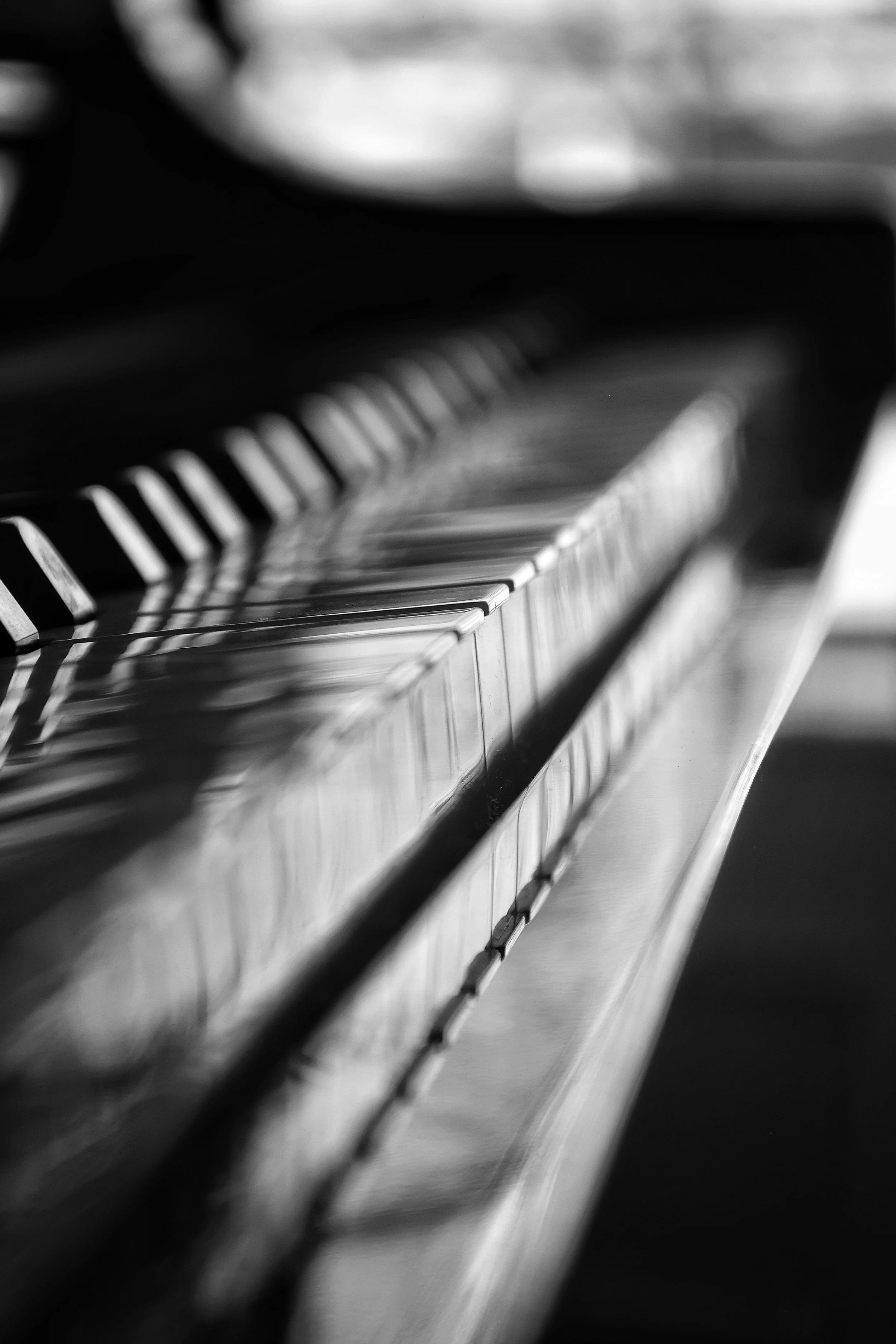 Black and white close-up of piano keys with focus on the middle keys.
