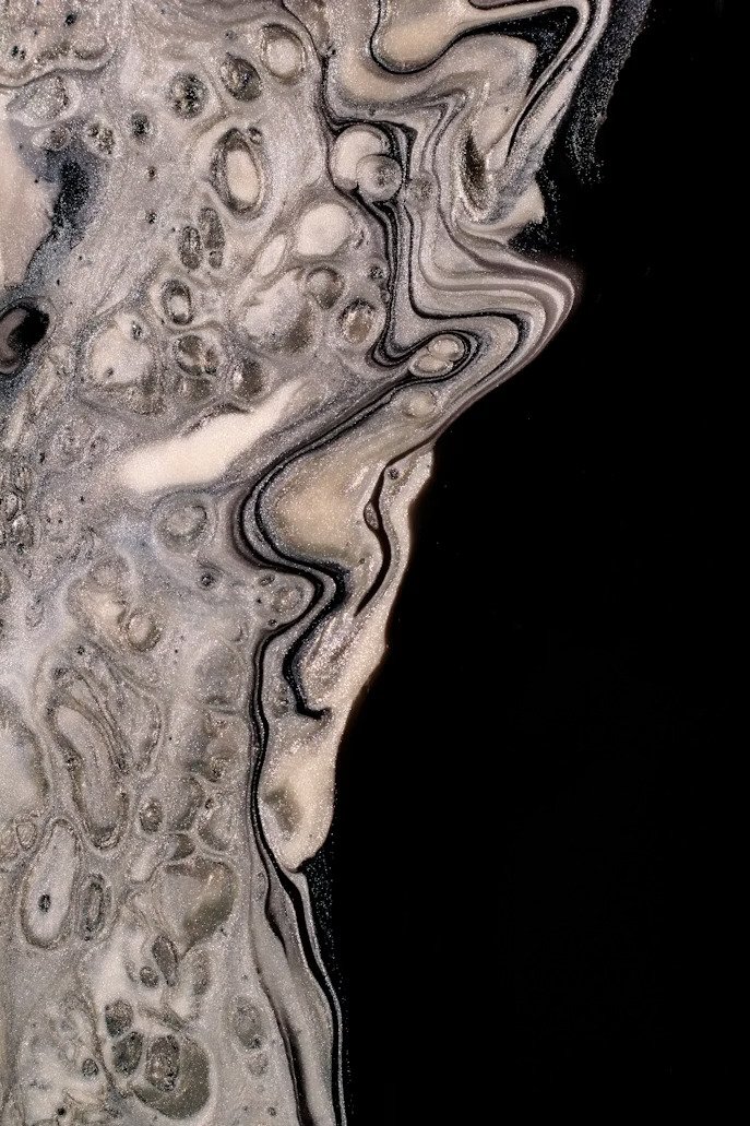 Abstract mixture of black, white, and gray swirling patterns and bubbles