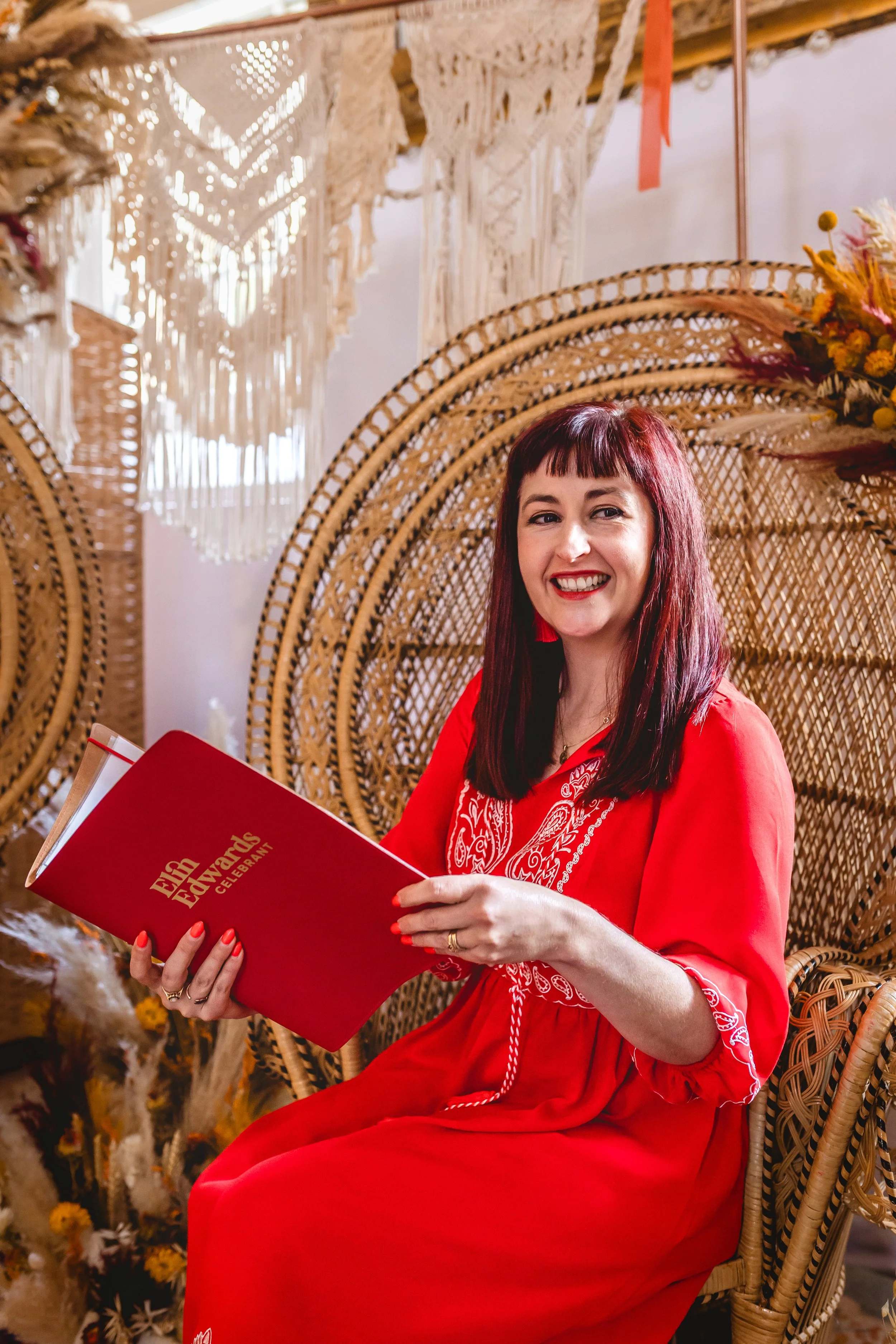 Elin Edwards Celebrant smiling with ceremony folder