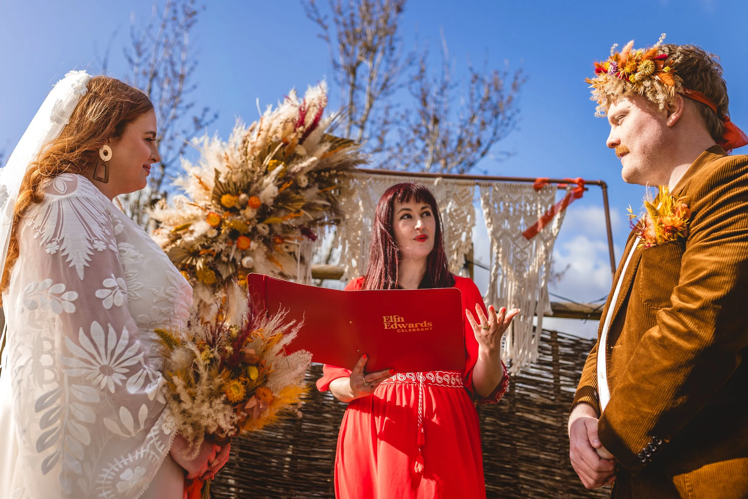 officiating celebrant Elin Edwards pictured with bride and groom outdoors wedding