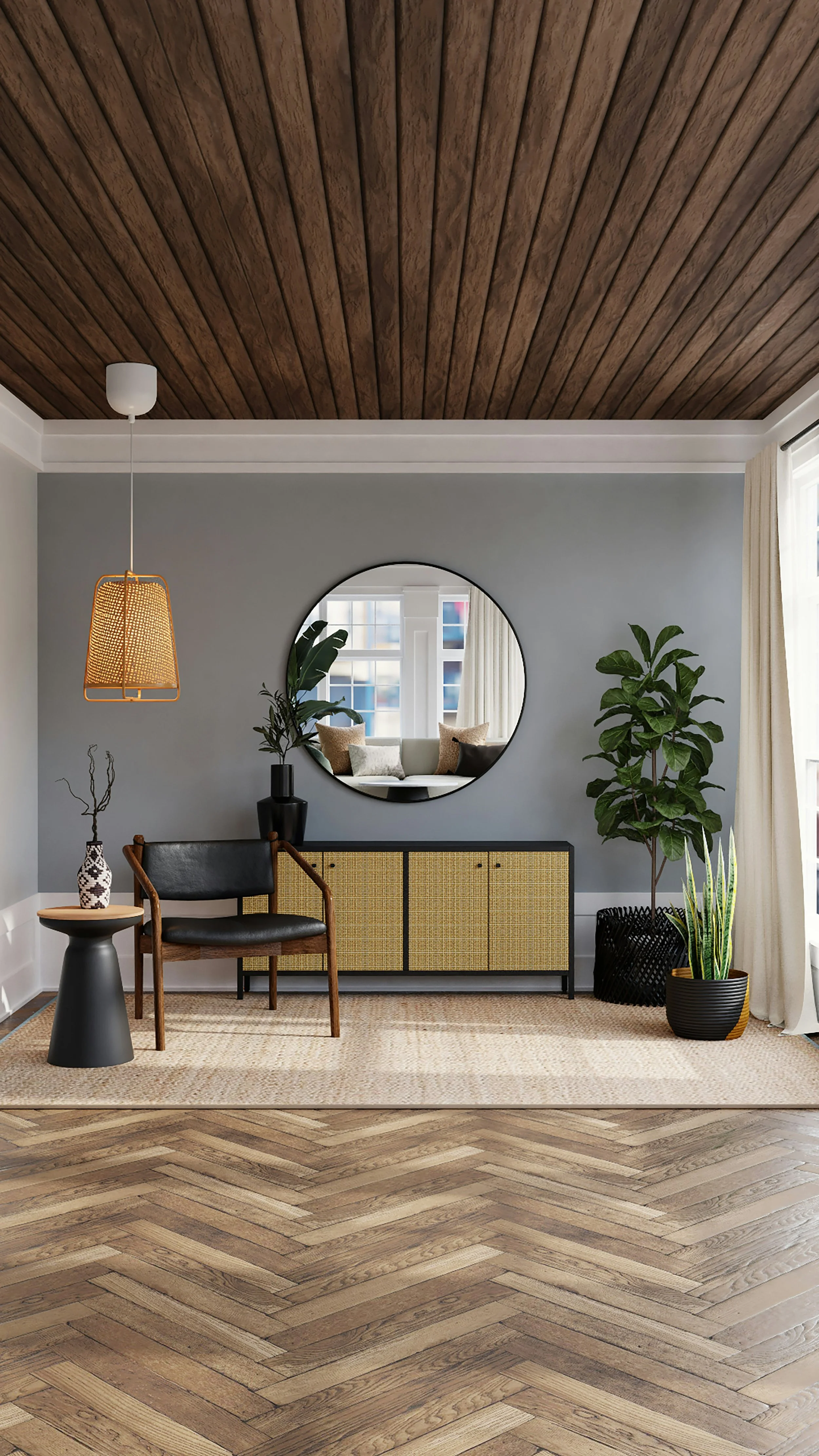Living room with a wooden ceiling, gray wall, round mirror, black and yellow sideboard, chair, small side table with a vase, indoor plants, large window with curtains, beige rug, and wooden herringbone floor.