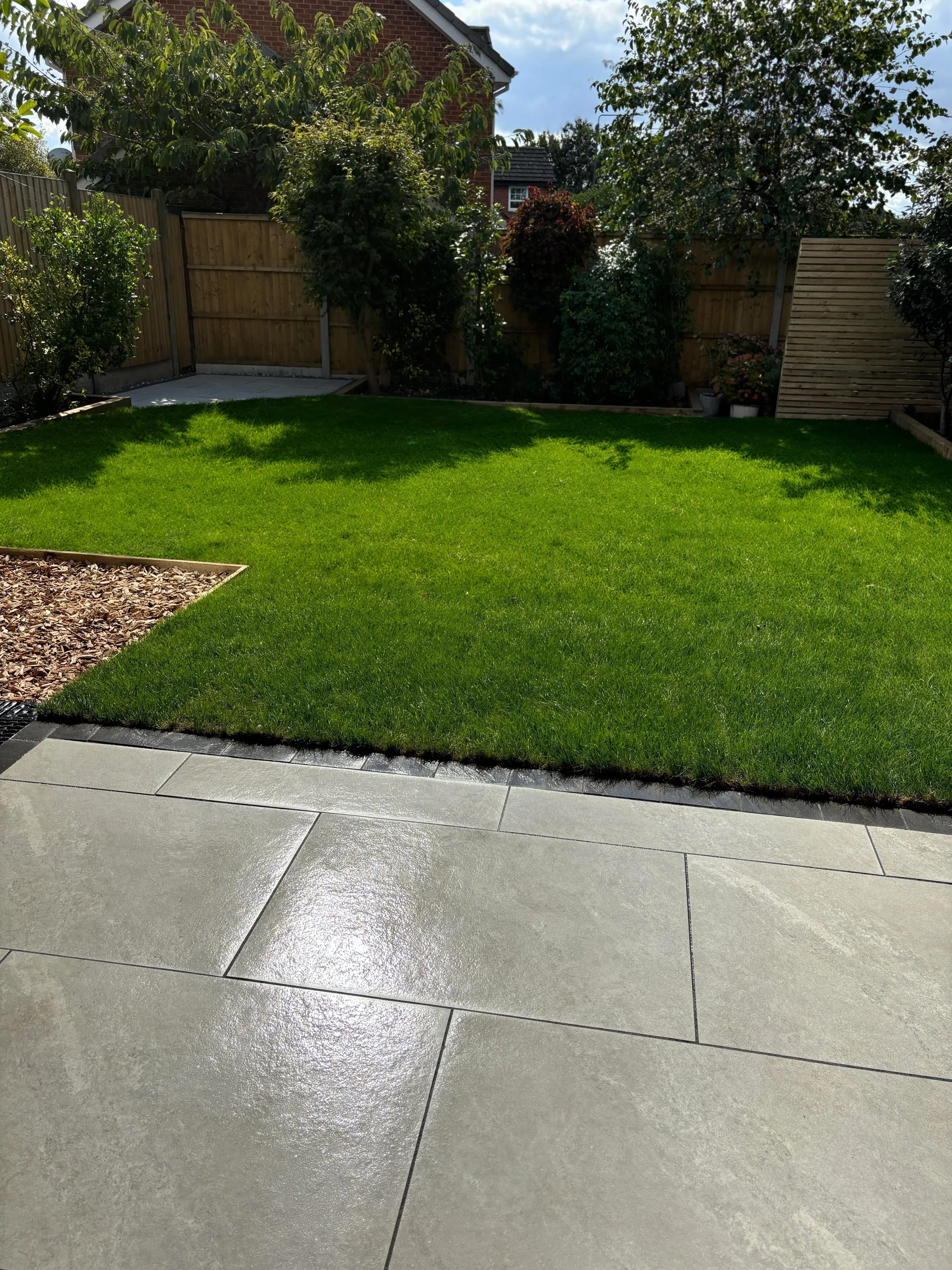 Picture showing the after of an overgrown, neglected garden following a tidy-up.