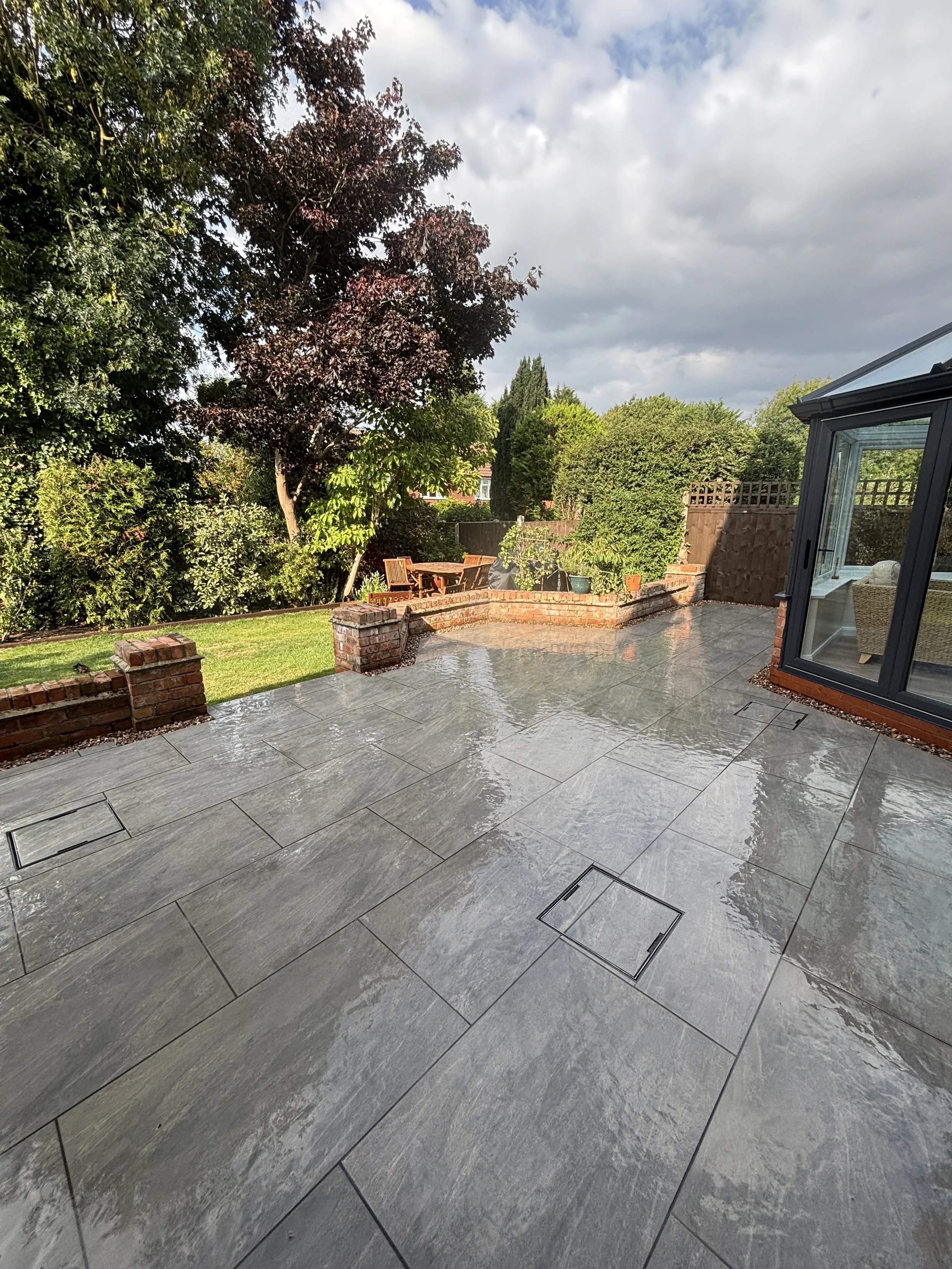Garden patio showing porcelain work with hidden, recessed manholes