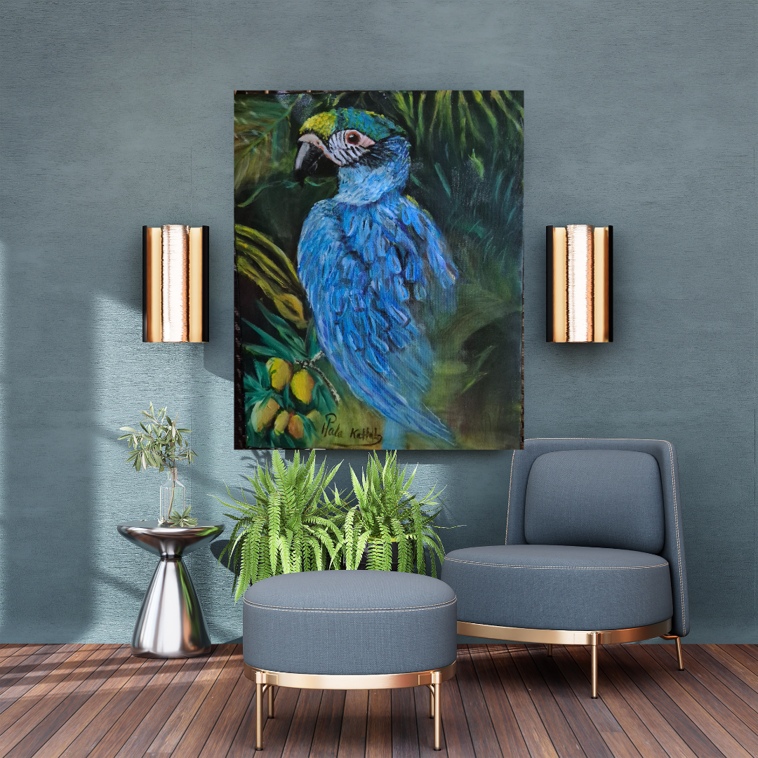 A blue parrot painting hangs on a teal wall between two modern wall sconces with gold and black accents. Below, there are green plants on a silver side table and on the floor. To the right, a blue upholstered chair and a matching ottoman are placed on a wooden floor.