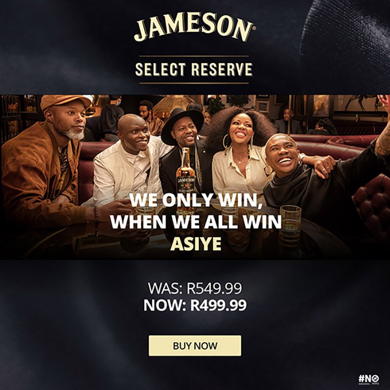 People sitting at a table in a bar, smiling and taking a selfie, with a bottle of Jameson whiskey in the foreground. Text promotes a Jameson select reserve offer, with a special price of R499.99.