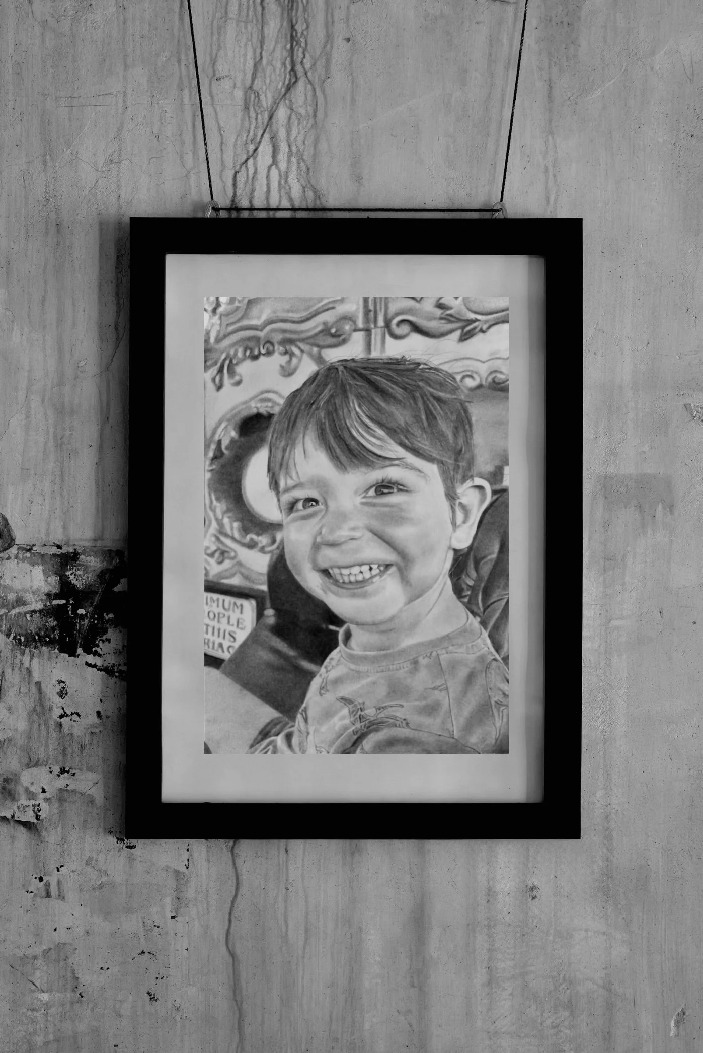 Black and white poster of a smiling young boy with short hair and a small jacket, standing outdoors in front of a decorative background.