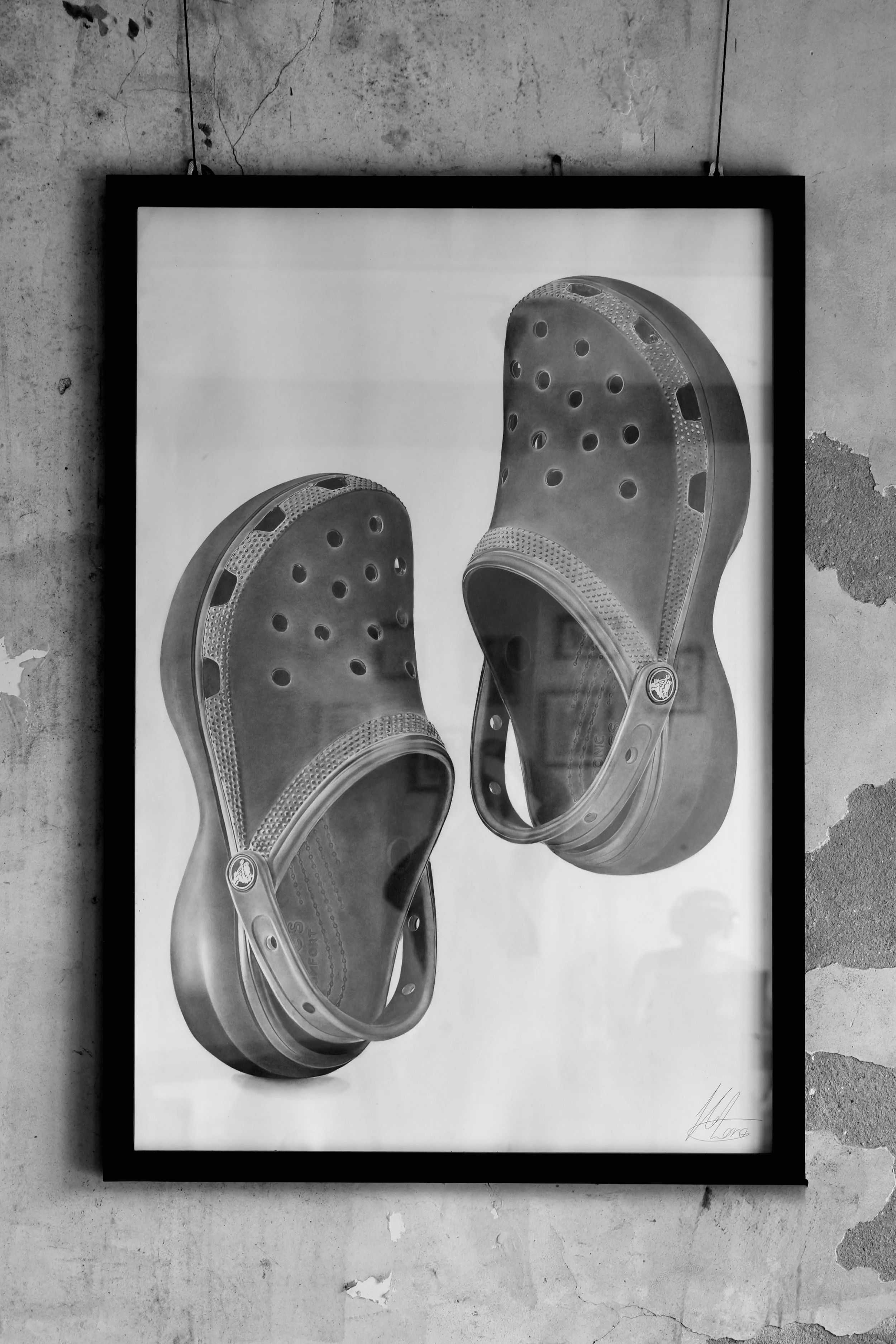 Black and white poster of a pair of Crocs shoes with holes and textured straps.