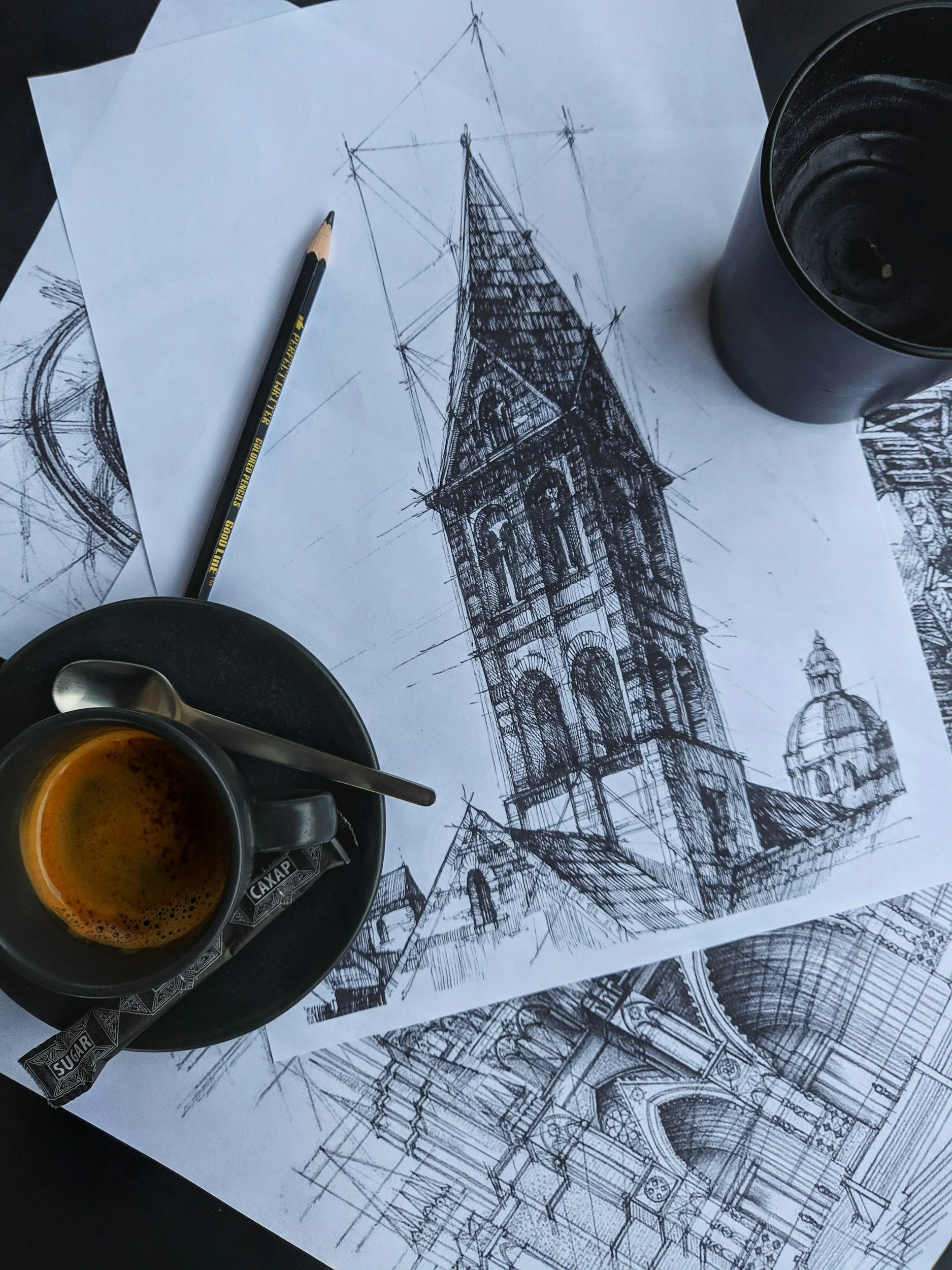 Sketch of a historic clock tower on architectural sketch, with a cup of espresso on a saucer, artists shadow on the drawing.