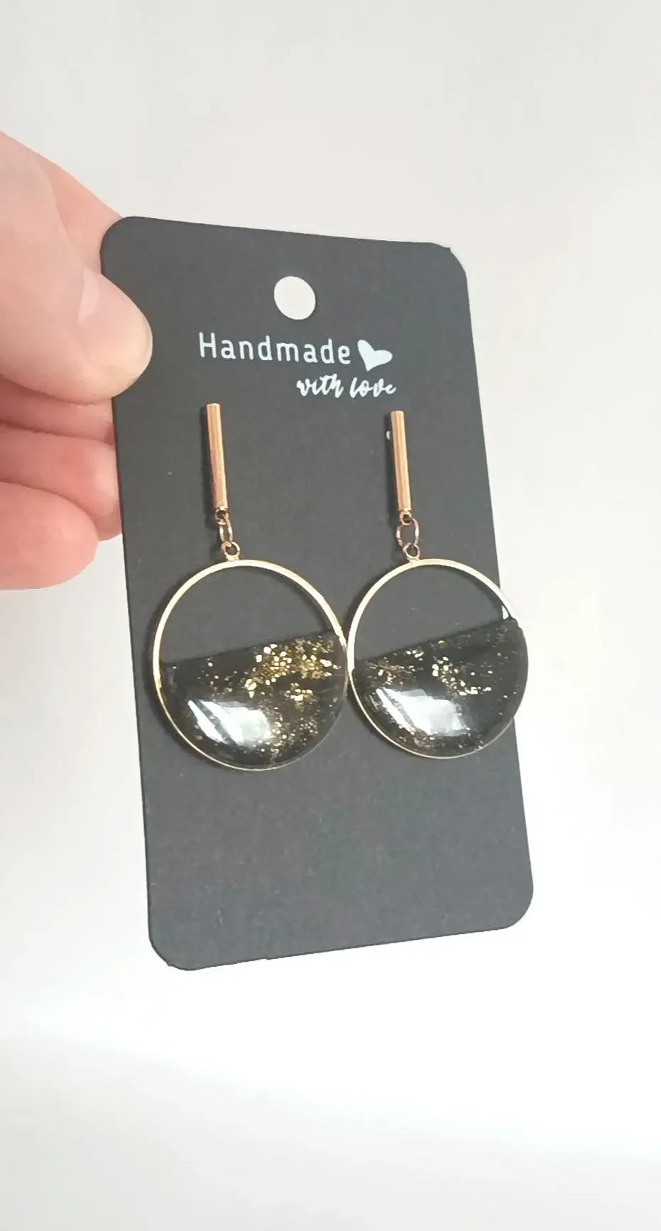 Minimalist red polymer clay circle earrings hanging from 14k gold-filled hooks. The round geometric dangles feature a matte red finish and are displayed on a white background.