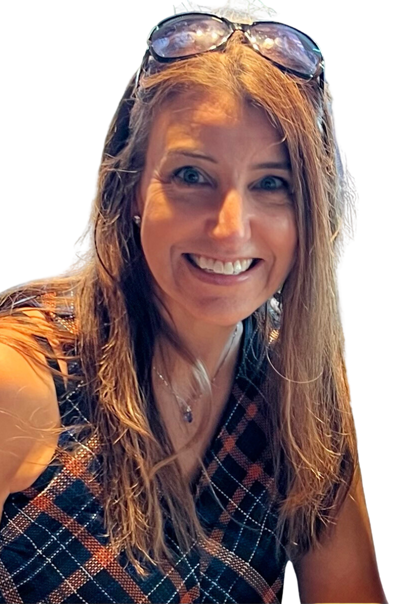 A smiling woman with long, wavy light brown hair, wearing glasses on her head, a sleeveless plaid top, and a necklace, against a mixed black and green background.