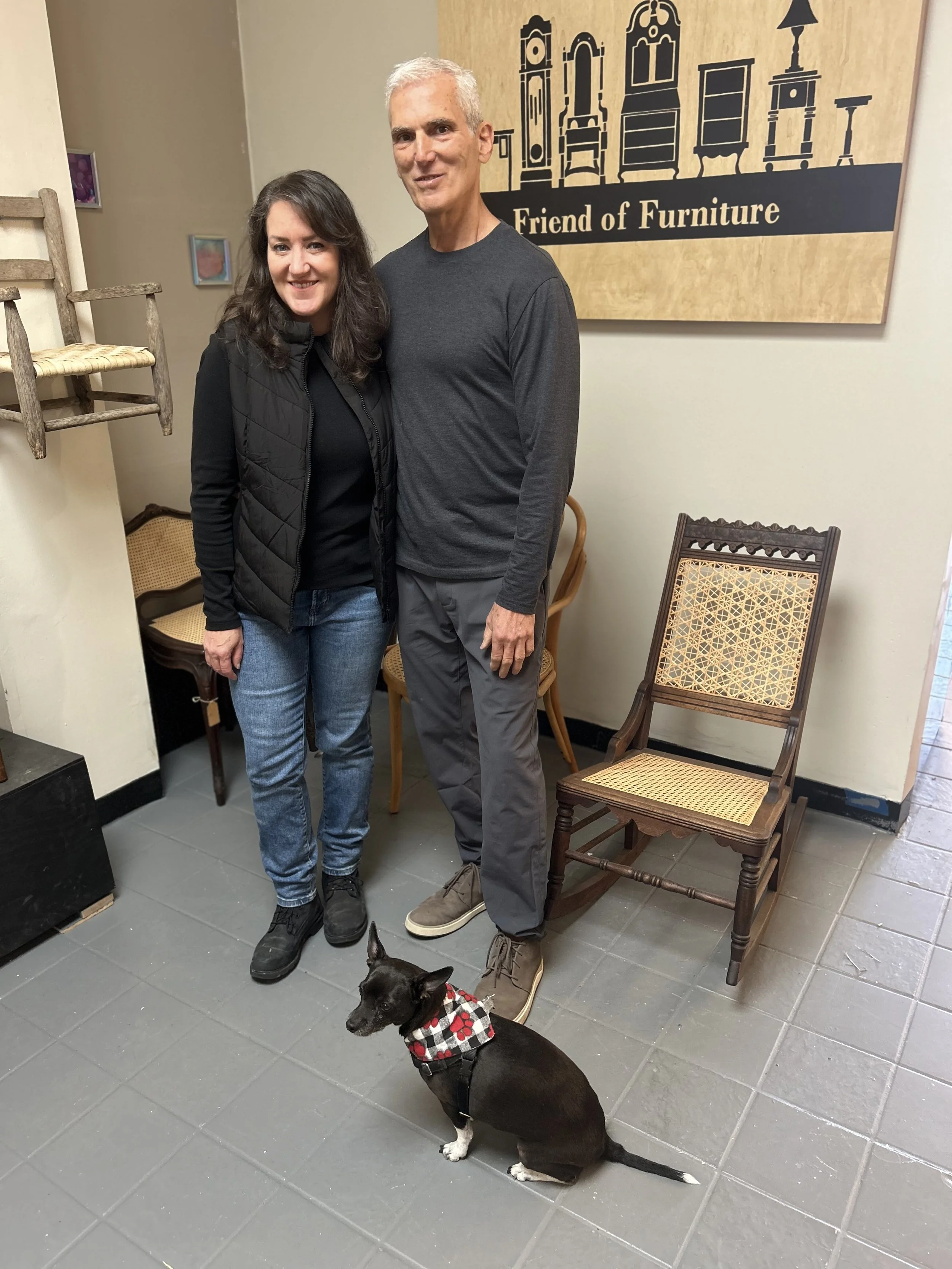 Deb and Mitch, owners of Friend of Furniture in their private workshop location on the South Slope where they work on chair caning and seat weaving with their dog Monique by their side.