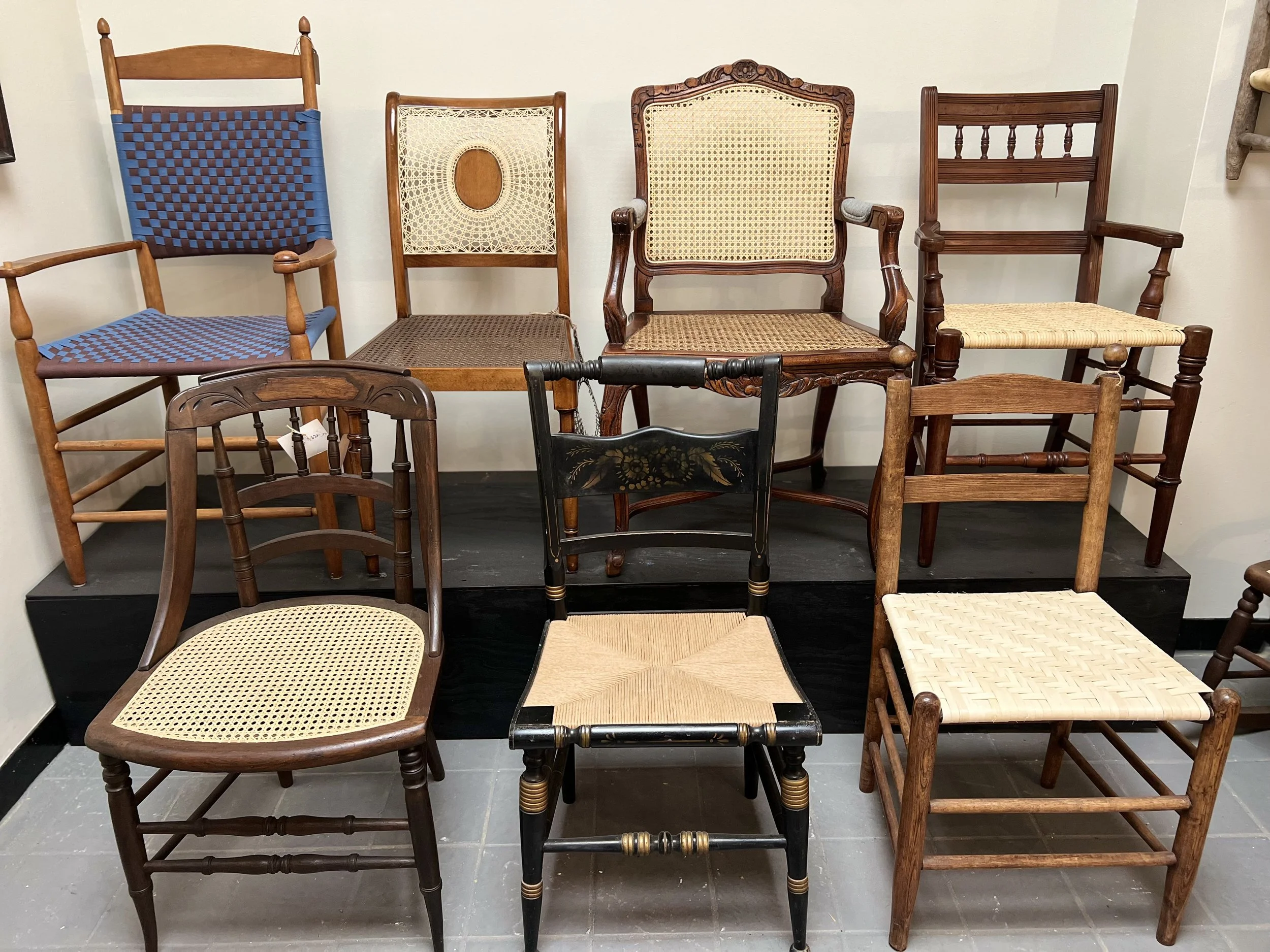 Collection of antique chairs with various woven seat styles available for restoration at Friend of Furniture.