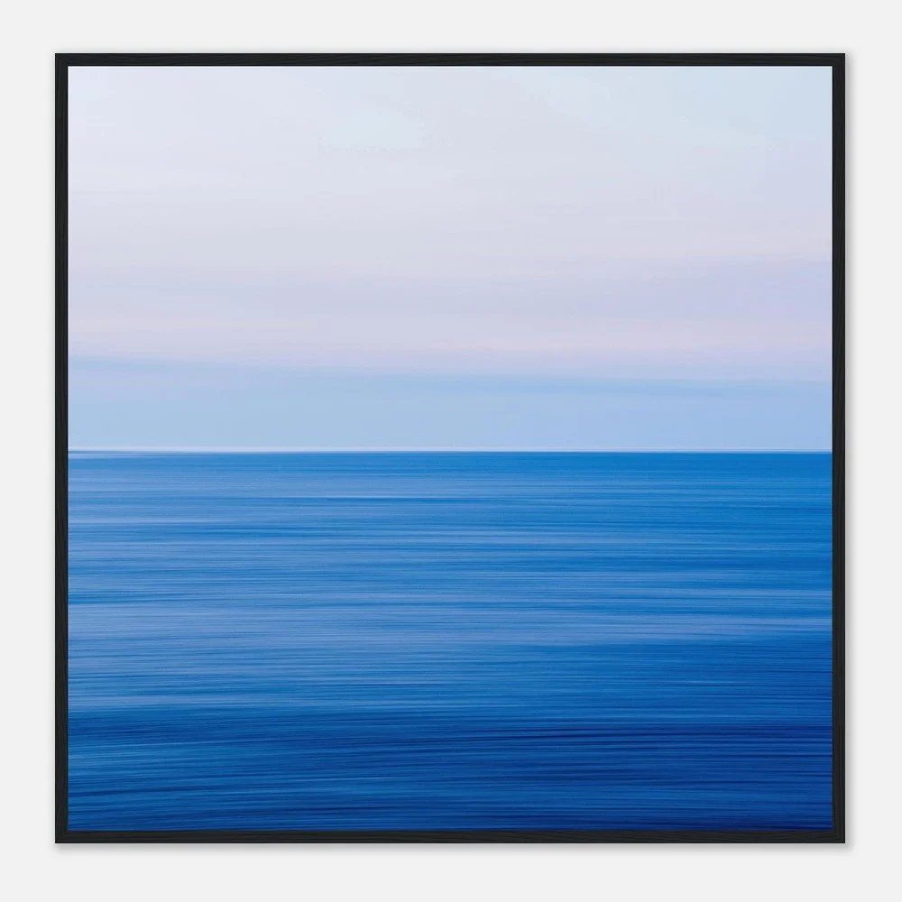 Abstract seascape painting with horizontal blue and light pink streaks, framed in black.