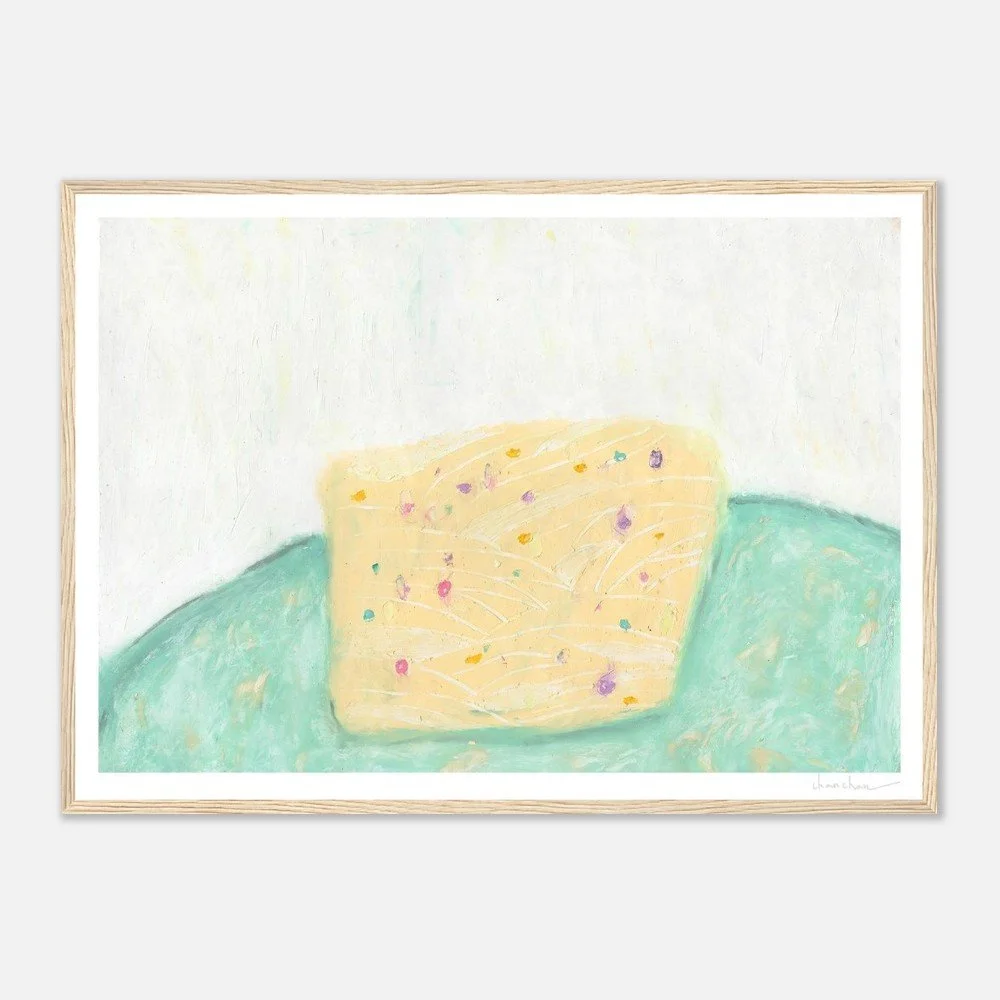 Oil pastel abstract artwork by Chan Chan showing a soft yellow cake resting on a green surface, rendered with playful texture and gentle color contrast.