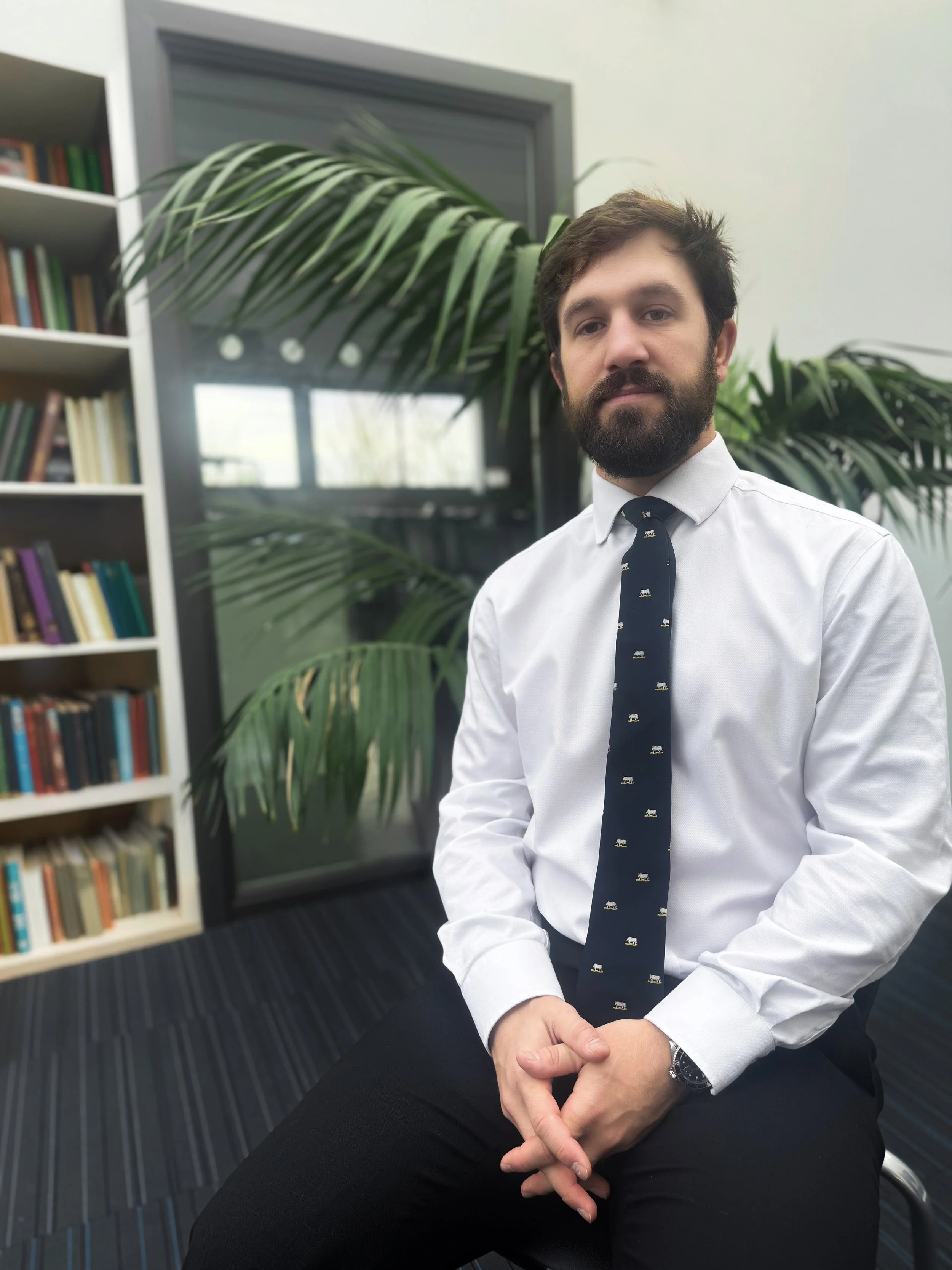 Nick Gardner sitting in front of a bookcase. PGCE and Masters in Education from Oxford University. More than a decade of experience as a teacher and head of department in some of the top schools in the UK.