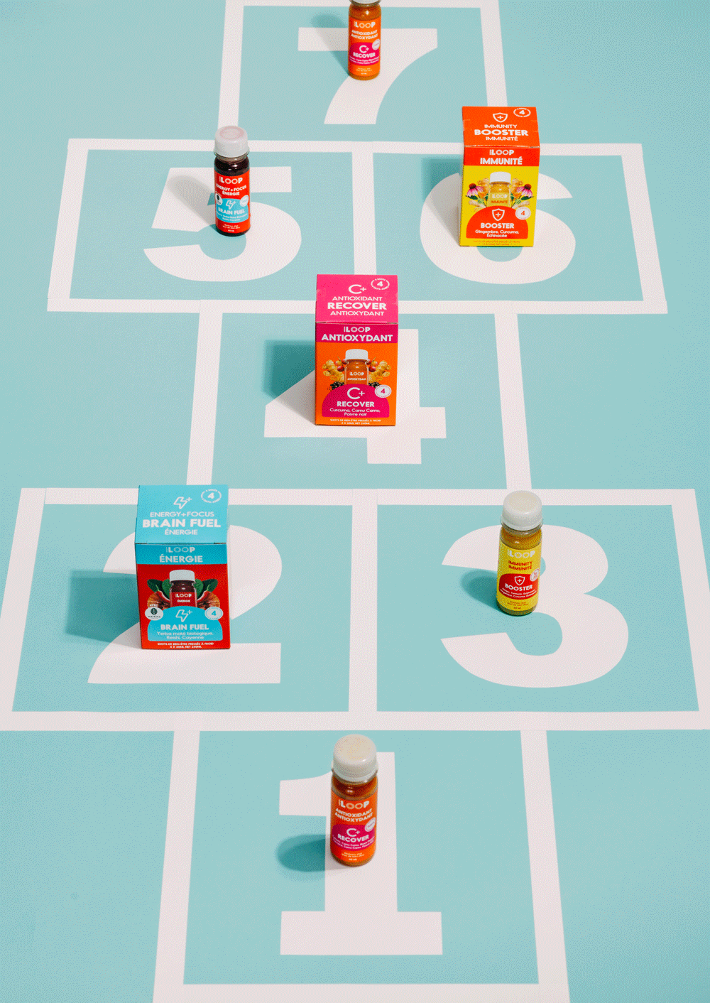 Arrangement of different health supplement bottles and boxes on a light blue tic-tac-toe board with numbered squares.