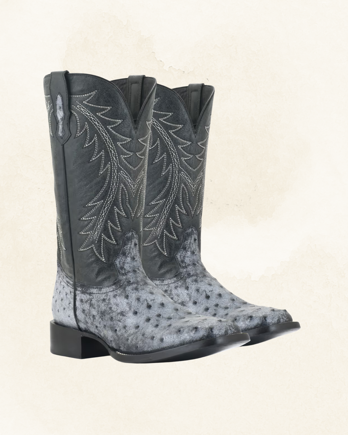 Black cowboy boots with white stitching on the shaft and a full quill ostrich design.