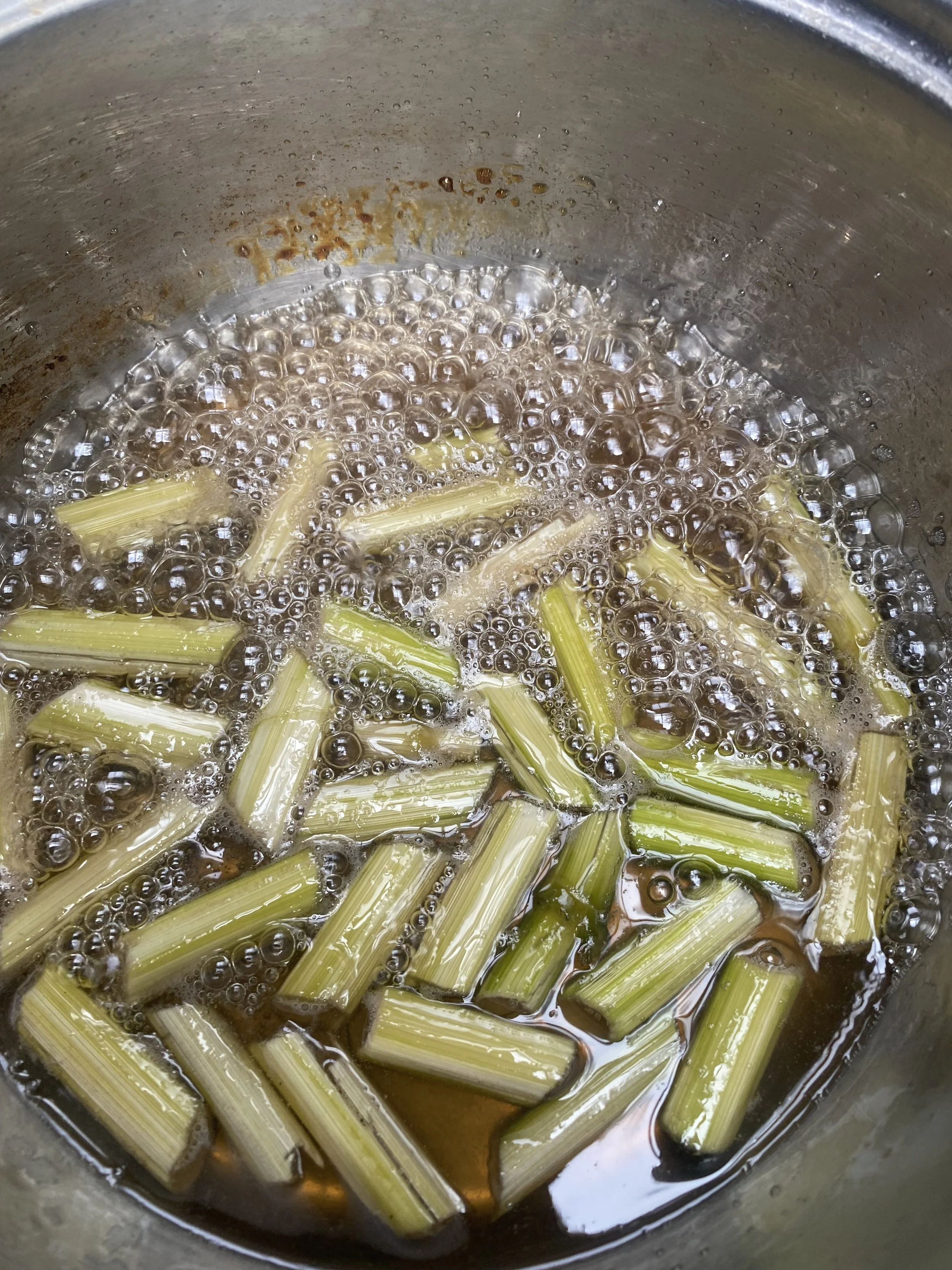 Celery stalks boiling in a pot.
