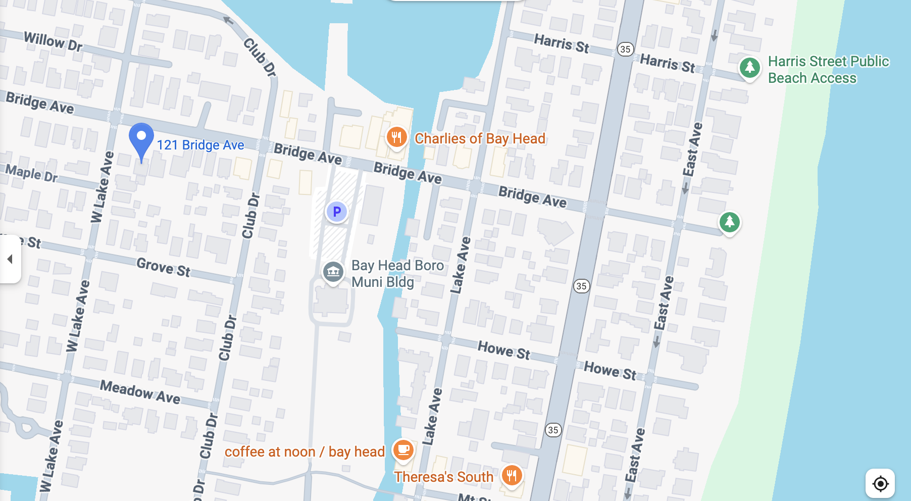 Map of a neighborhood showing streets, businesses, parks, and a beach access point along the shoreline. Key streets include Bridge Ave, East Ave, Lake Ave, and Club Dr. Notable locations include Charlie's of Bay Head, Theresa's South, and public beac