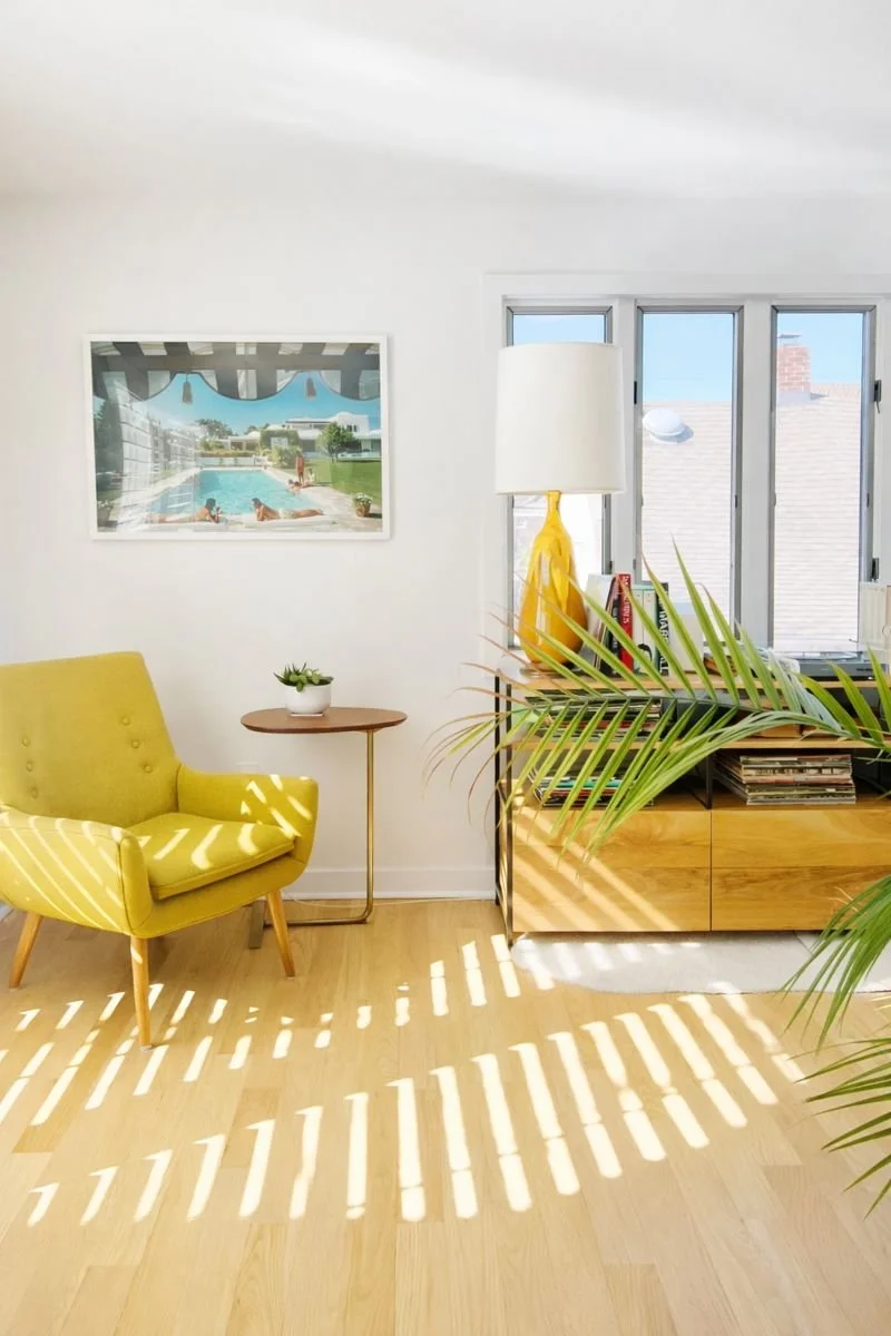 The rear of the house has a seating area before leading to the back deck. We love this print of Slim Aarons "Poolside in Sotogrande" which inspired some of the home design. 
