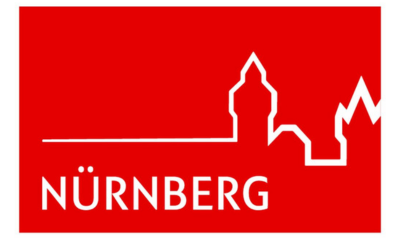 Rotes Hintergrundbild mit weißen Linien, die die Skyline von Nürnberg zeigen, und dem Text 'Nürnberg'.