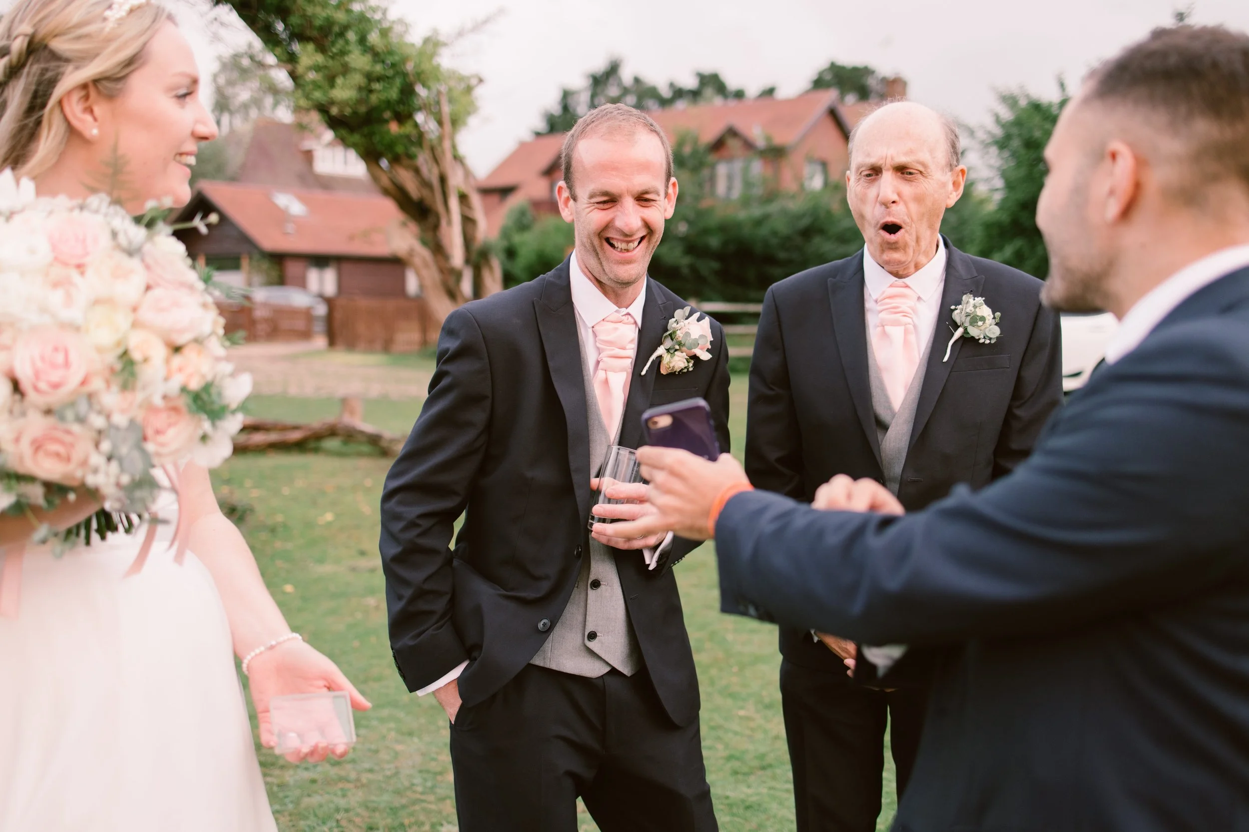 Wedding magician Alfie performing close-up magic for guests at UK wedding reception