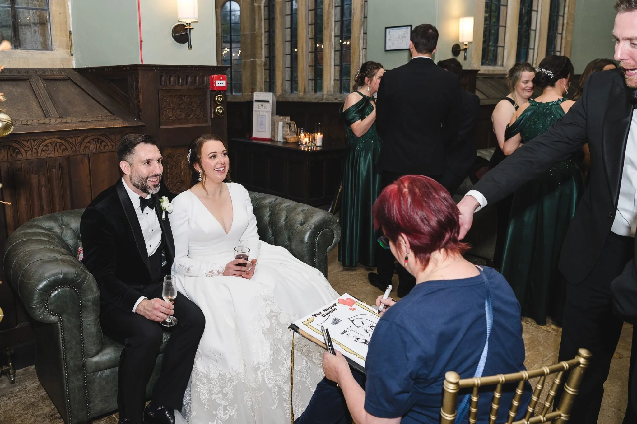 Bride and groom having their caricature taken during the drinks reception