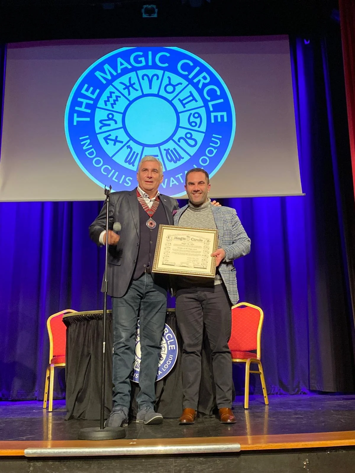 Magic by Alfie receiving his Magic Circle membership certificate from President Marvin Berglas on stage