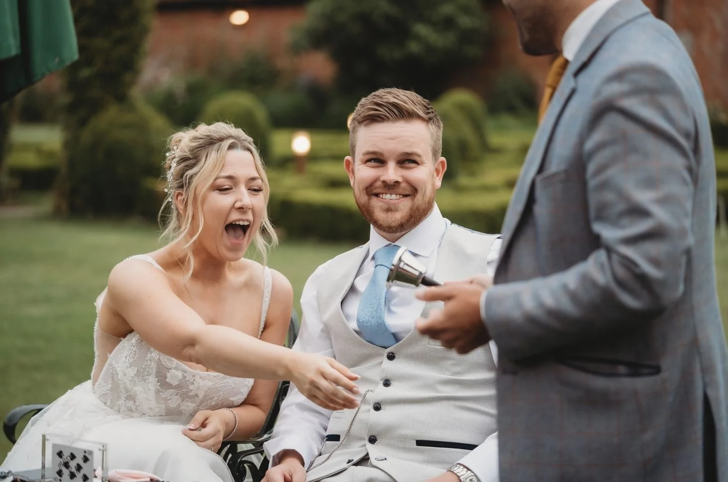 Professional magician performing close-up magic for bride and groom at a Dorset wedding venue