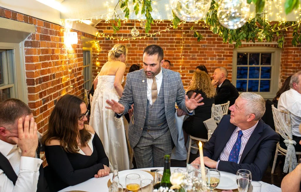 Guests enjoying a close-up magic performance at a Wiltshire countryside wedding or event