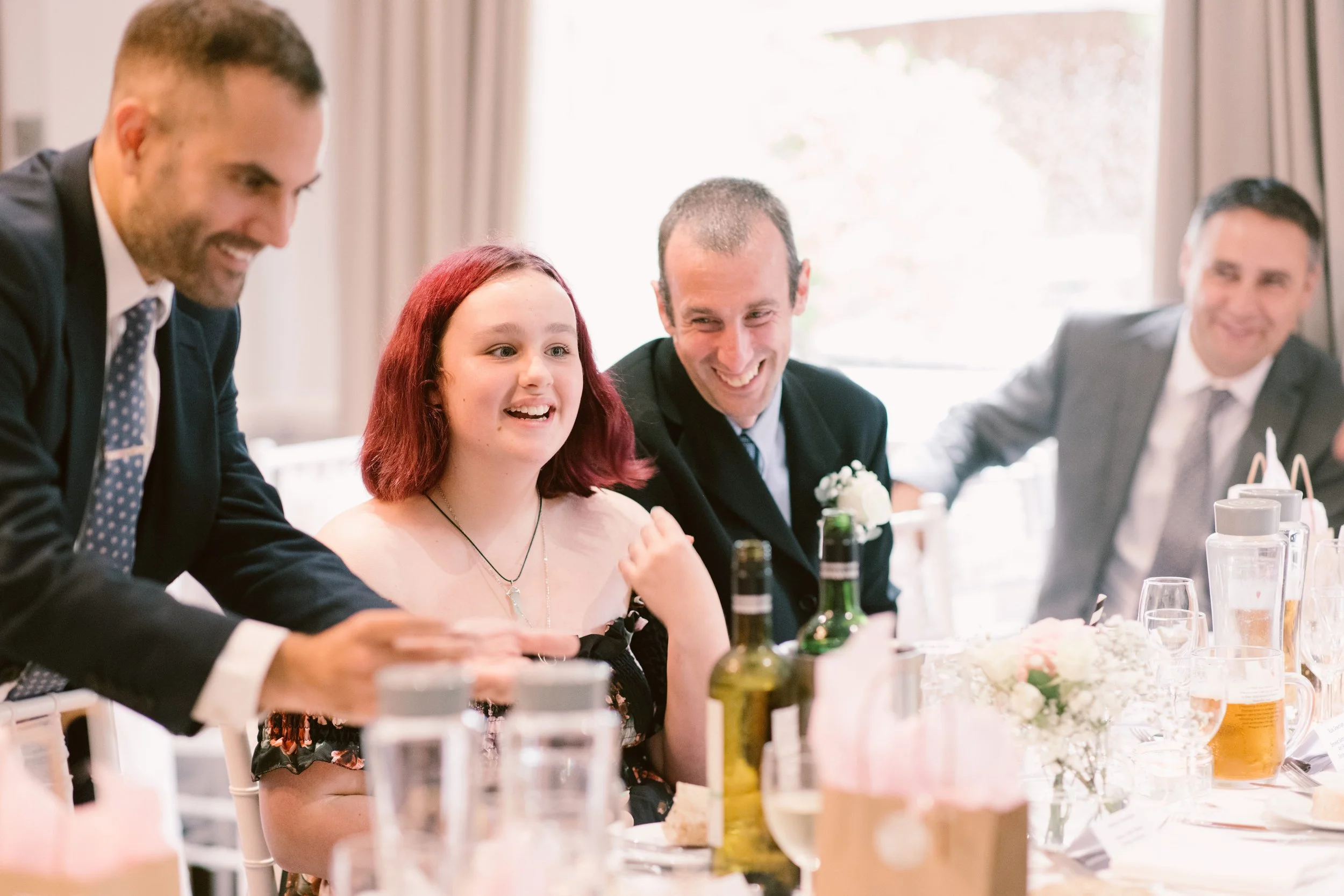 Modern wedding magician entertaining guests during wedding breakfast