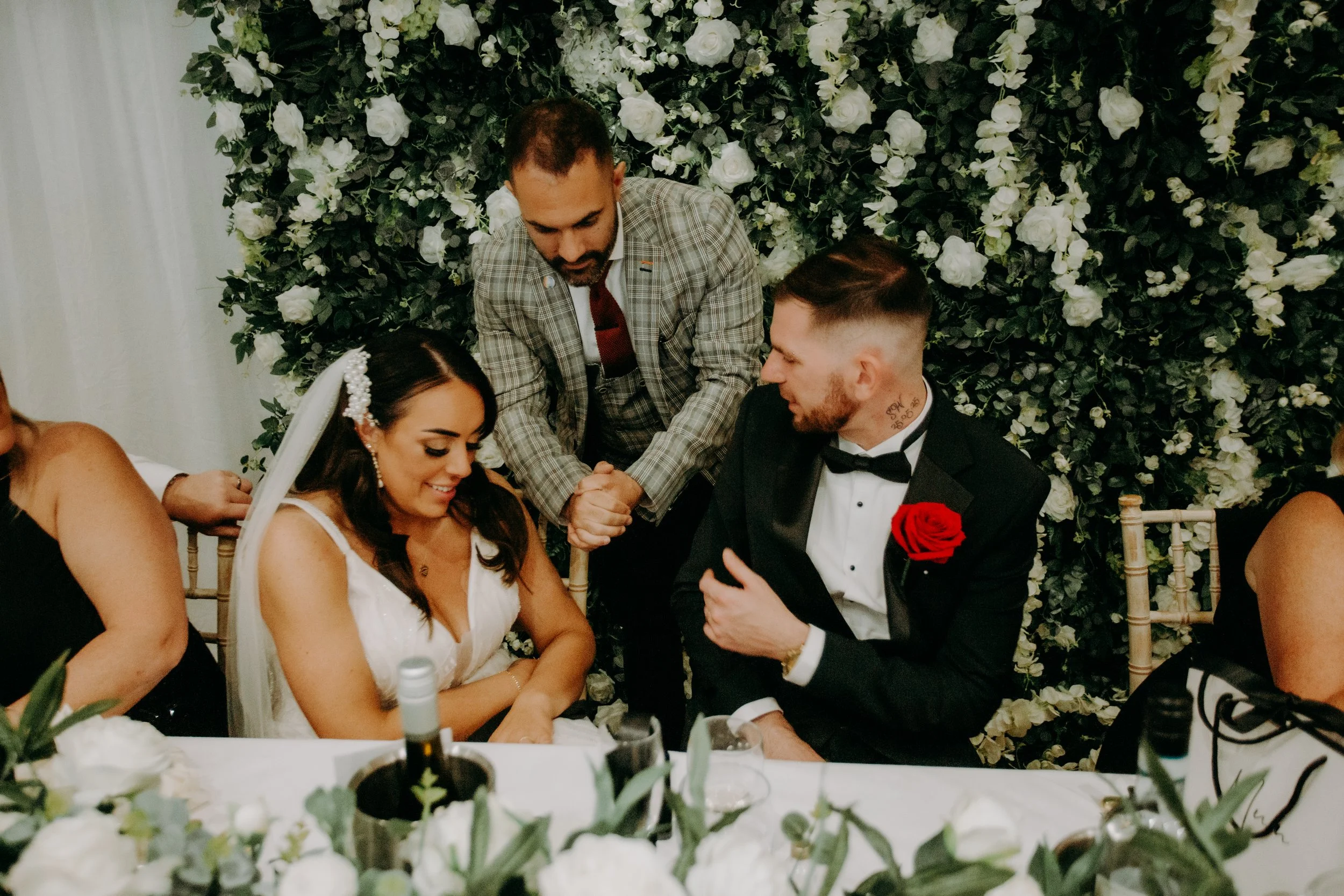 Close-up magic being performed for bride and groom during the wedding breakfast.