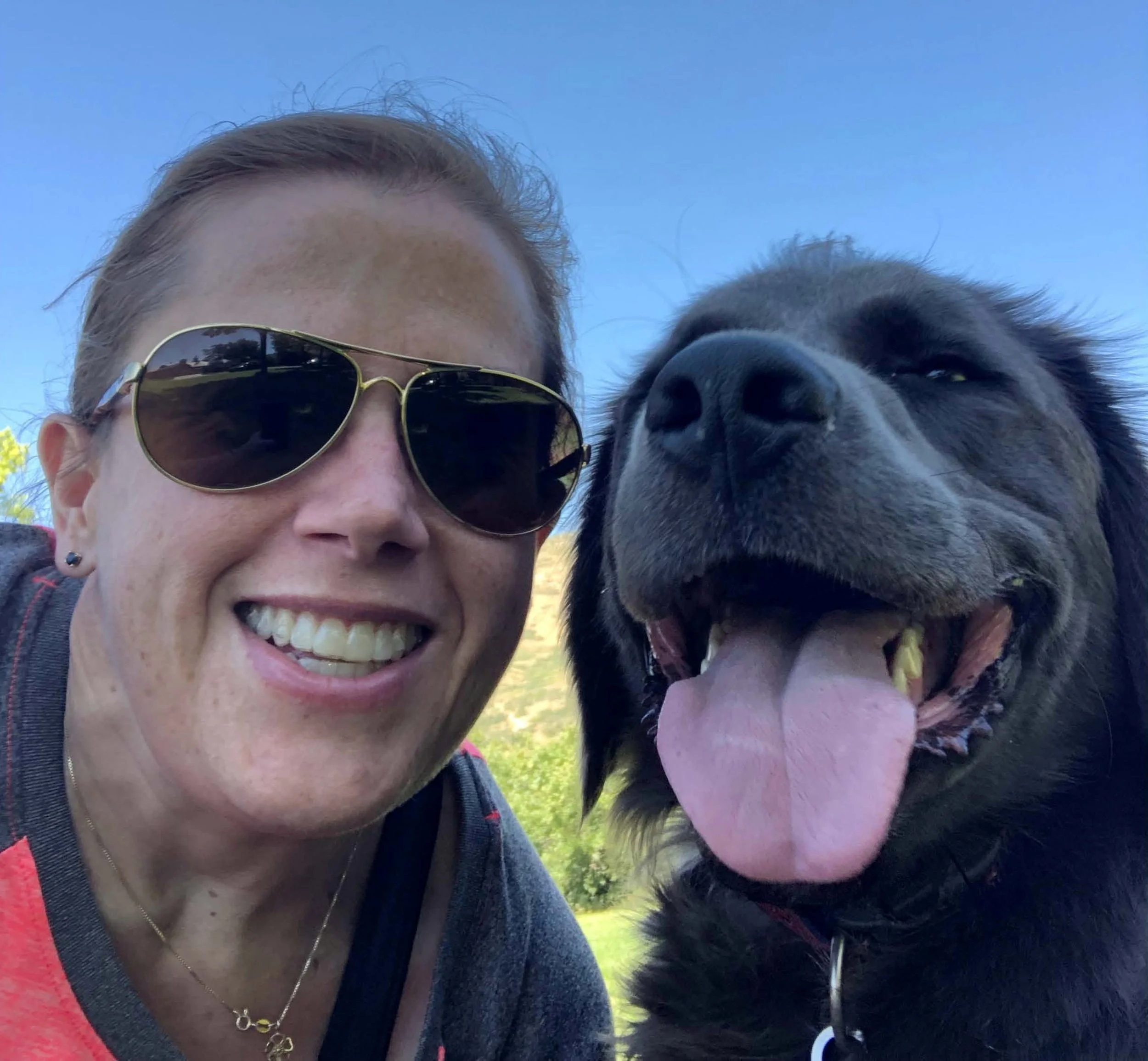 Missi Bunker and her dog, Ted Williams, smiling at the camera