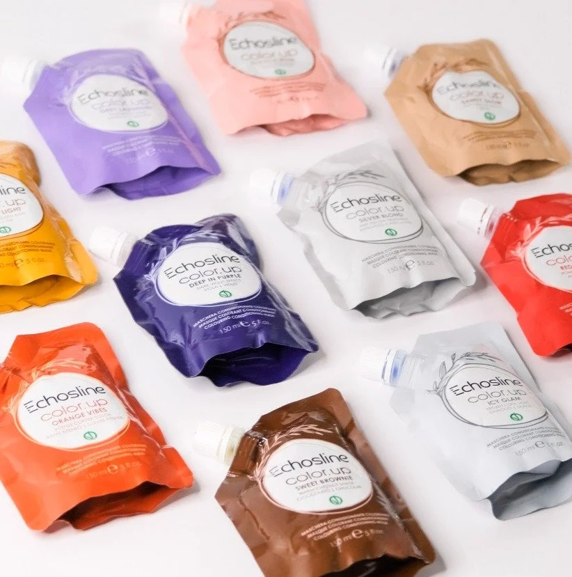 Set di tube di colorante color up, echosline, per capelli di vari colori, tra cui viola, rosa, marrone, bianco, arancione, rosso, e beige, disposti su uno sfondo bianco.