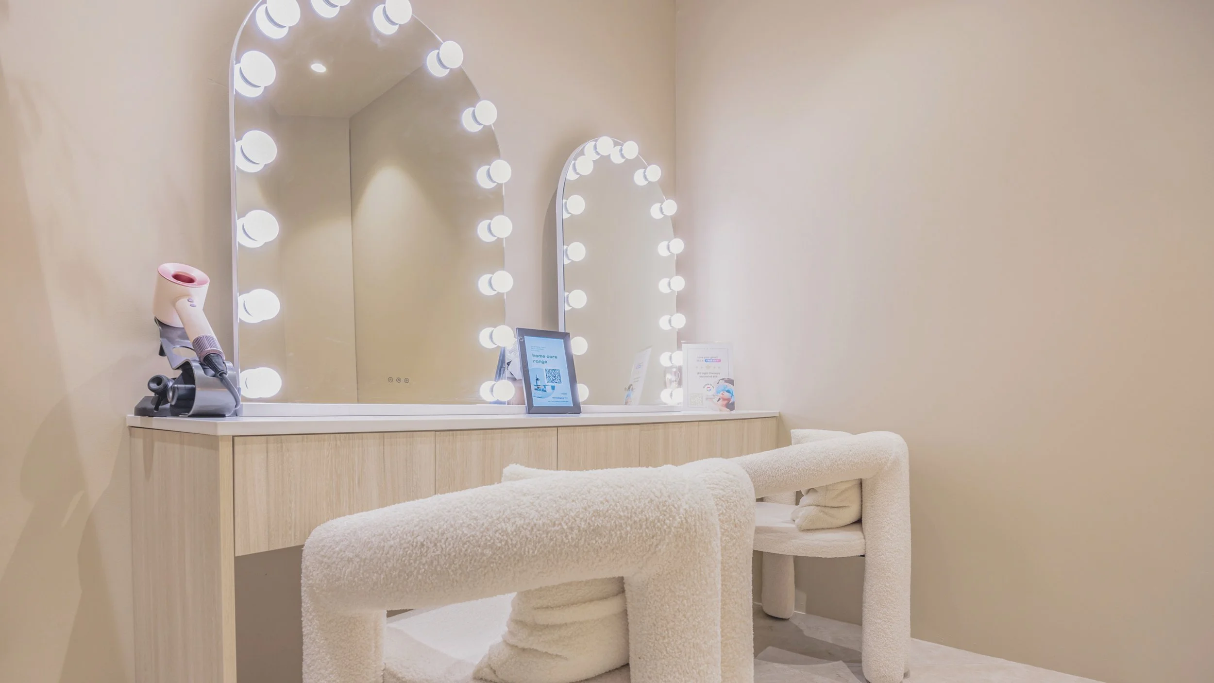 Post-treatment loung with Hollywood mirror and boucle stool at Noa Skin Zetland — the finishing touch to every facial in Sydney
