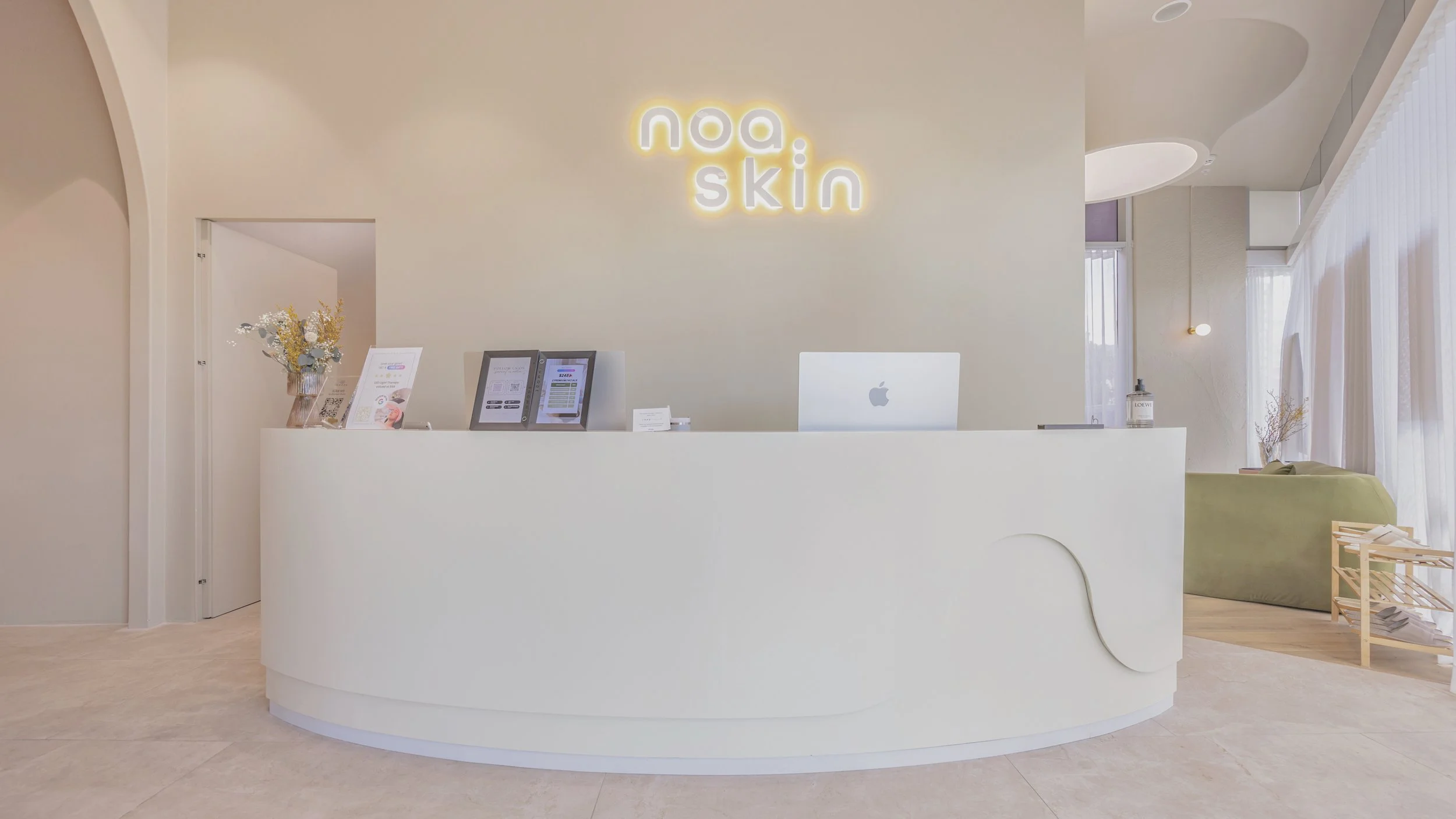 Reception desk with noa. skin neon signage at our Zetland skin clinic — welcoming Sydney clients to our science-backed skin lab