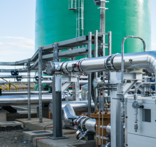 Industrial pipes and tanks at a manufacturing facility.