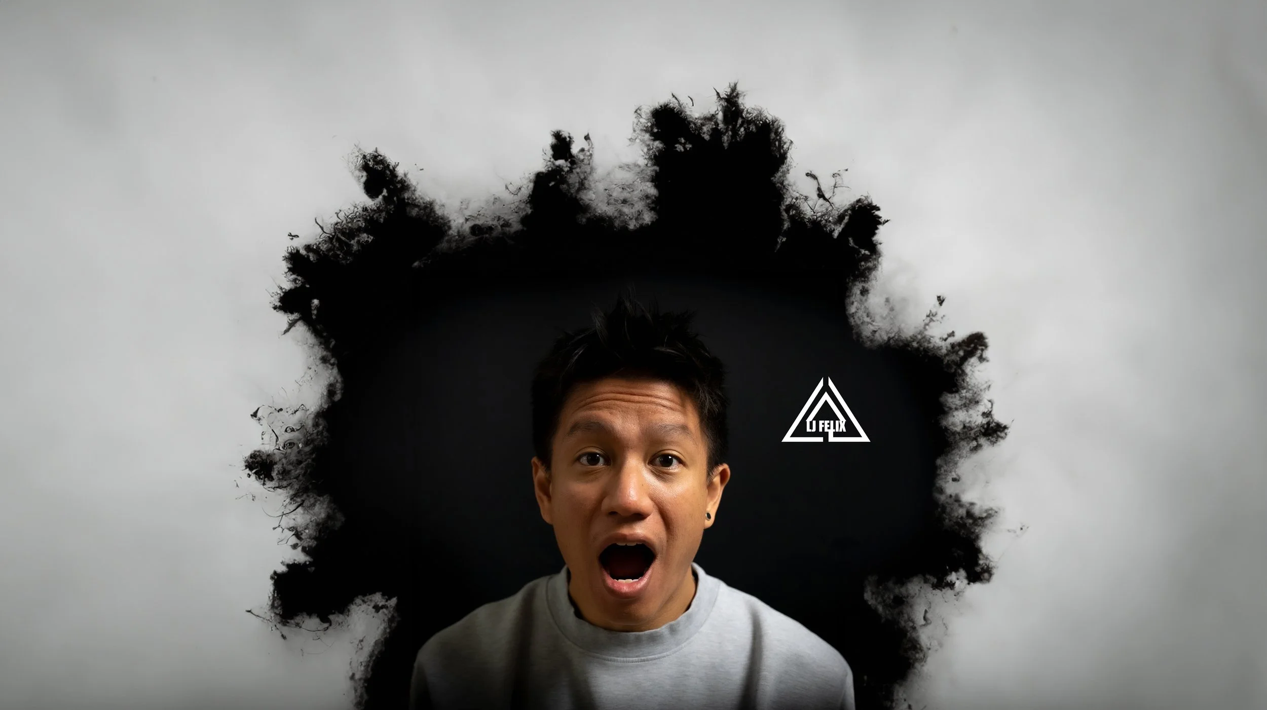 Person with surprised expression in front of a black and white wall with a white logo and dark ink splash surrounding the head.