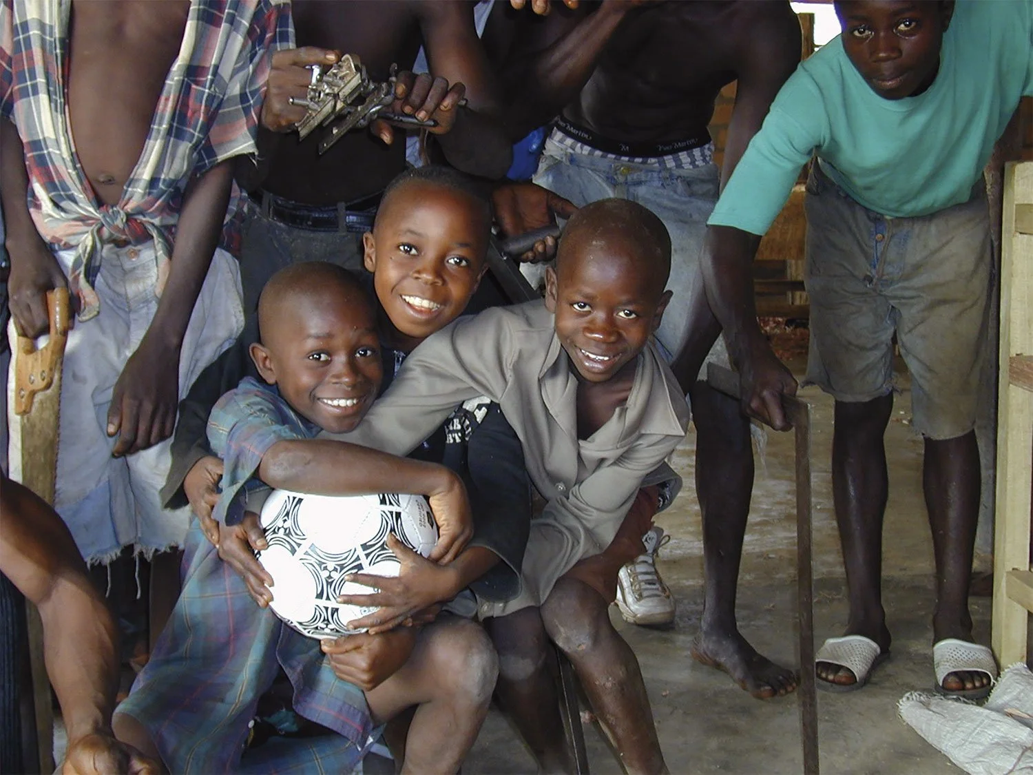 A group of child soldiers in Sierra Leone are happy to receive a football from Batemans in Stroud