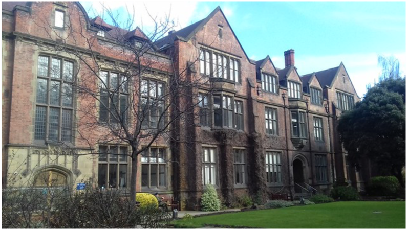 The front of the Department of Agriculture at Kings College, Newcastle UK with a blue sky and white clouds