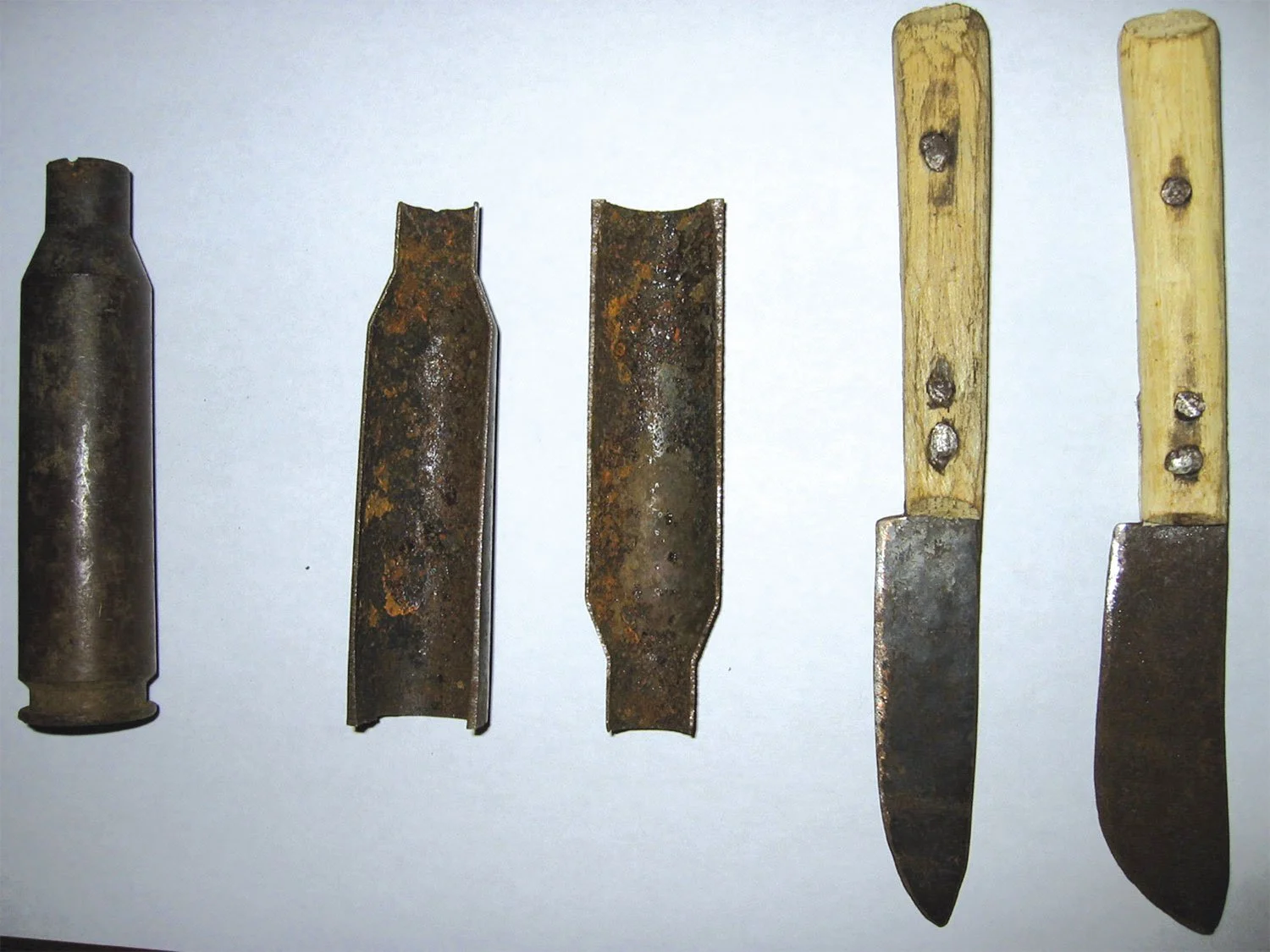 Five utility tools made from 50 mm artillery shells in Sierra Leone, converted into kitchen knives.