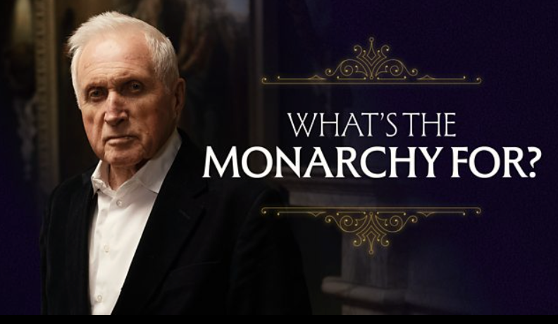 David Dimbleby wearing a suit and white shirt standing inside a dimly lit room. Next to him, a graphic with the text 'What's the Monarchy For?' in white letters on a dark purple background