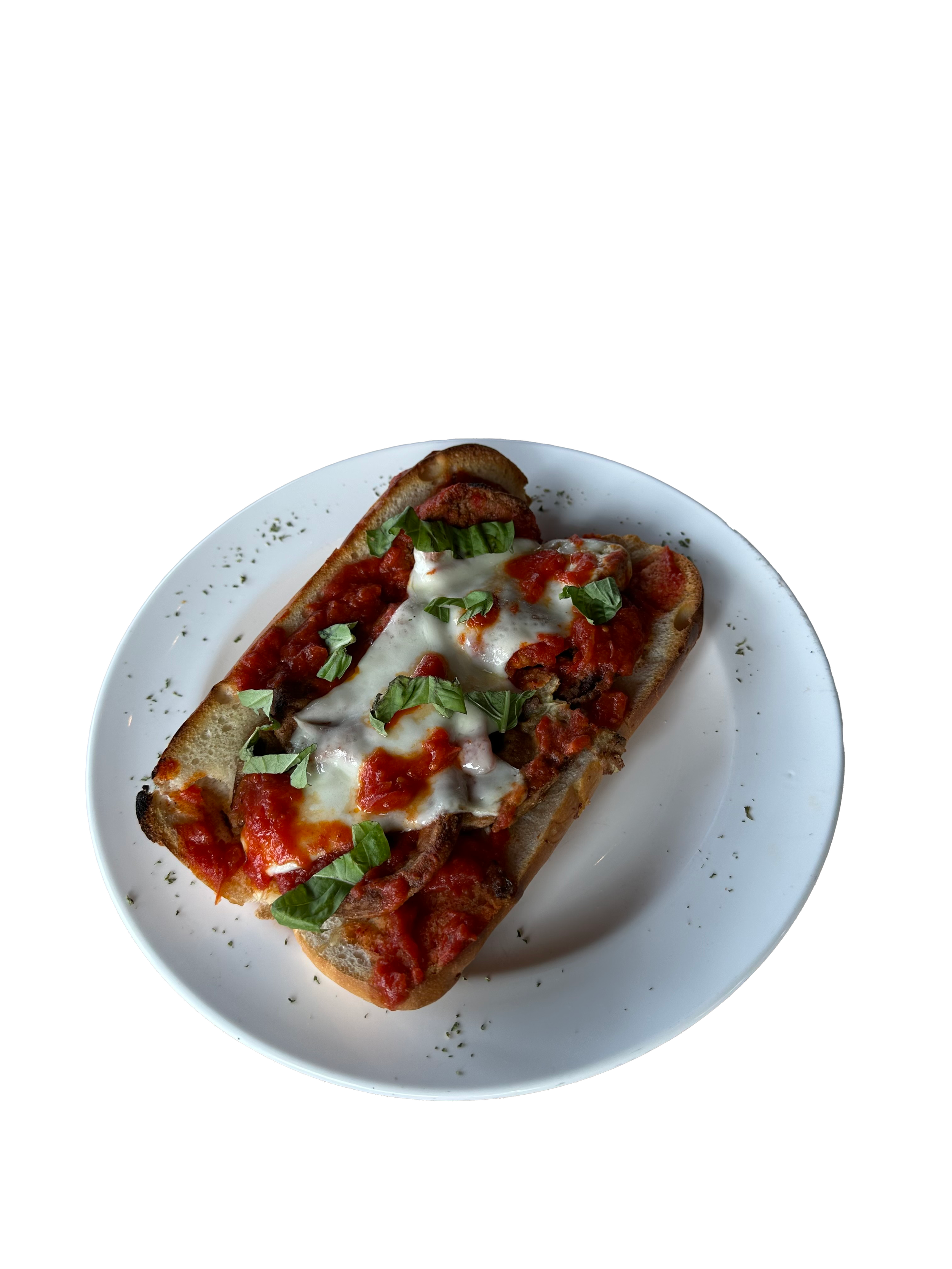 A plate with a toasted Italian sandwich topped with melted cheese, tomato sauce, fresh basil, and herbs.
