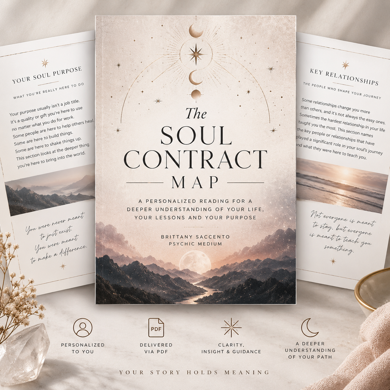 The cover of a book titled "The Soul Contract Map" featuring celestial imagery and mountain landscape, surrounded by informational sheets and decorative objects.