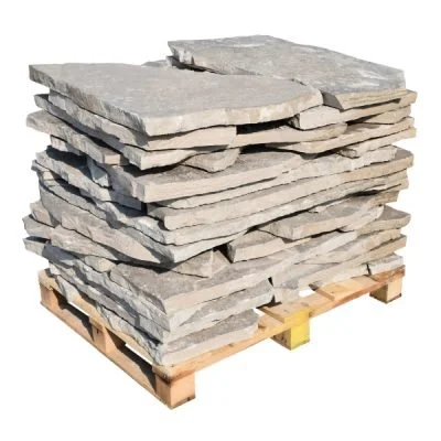 A pallet stacked with large, flat gray stone slabs.