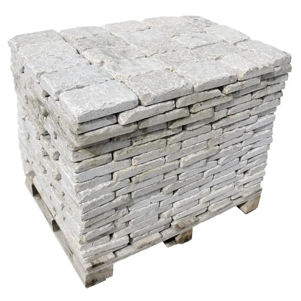 Stack of gray stone bricks on a wooden pallet.