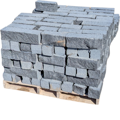 Stack of gray concrete bricks on a wooden pallet.