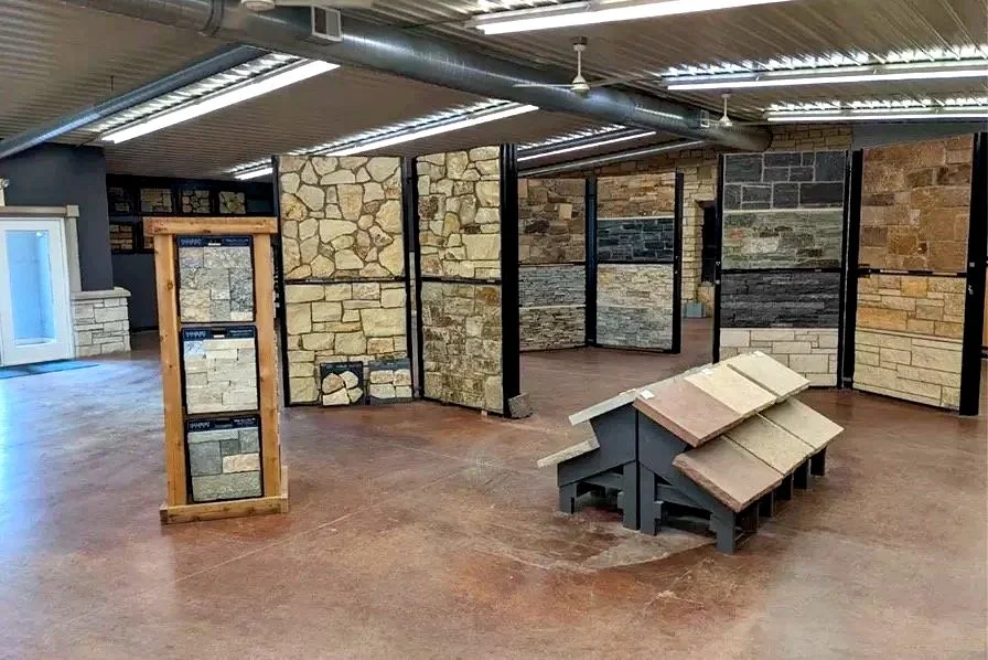 Display of various stone and brick siding samples in a showroom.