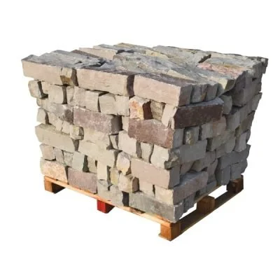 Stack of irregularly shaped stone bricks on a wooden pallet